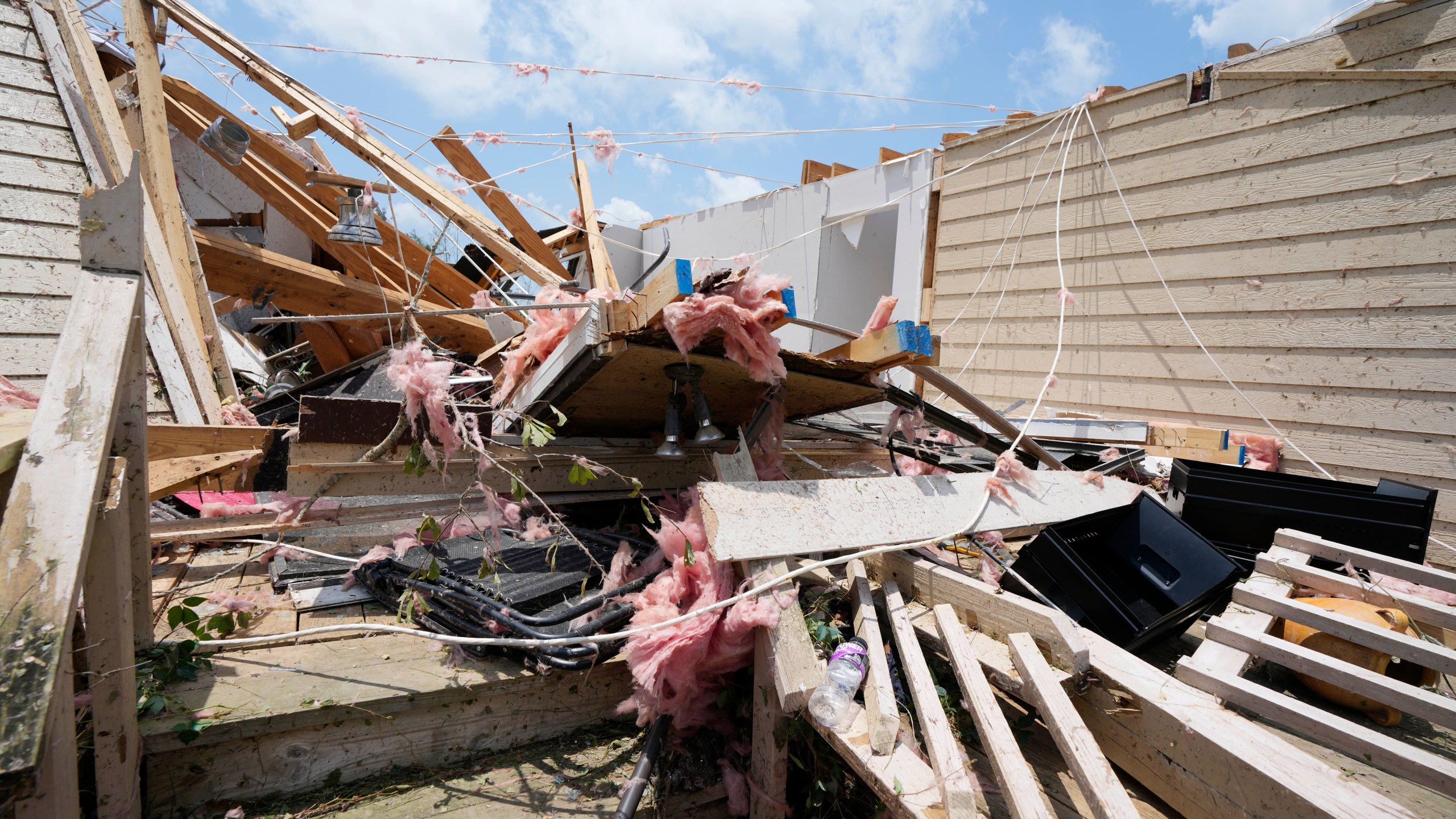 Debris litters a home following a Sunday night tornado that swept through Louin, Miss., Monday, June 19, 2023. (AP Photo/Rogelio V. Solis)