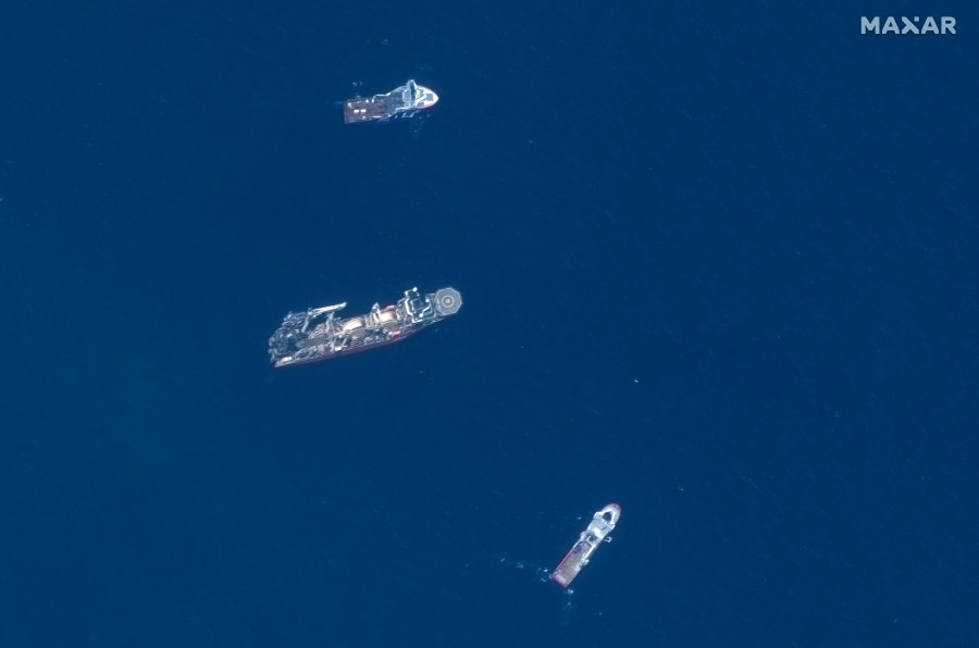 FILE - In this satellite image provided by Maxar Technologies, from top to bottom, the vessels Horizon Arctic, Deep Energy and Skandi Vinland search for the missing submersible Titan, Thursday, June 22, 2023, in the Atlantic Ocean. The wrecks of the Titanic and the Titan sit on the ocean floor, separated by 1,600 feet (490 meters) and 111 years of history. How they came together unfolded over an intense week that raised temporary hopes and left lingering questions. (Satellite image ©2023 Maxar Technologies via AP, File)