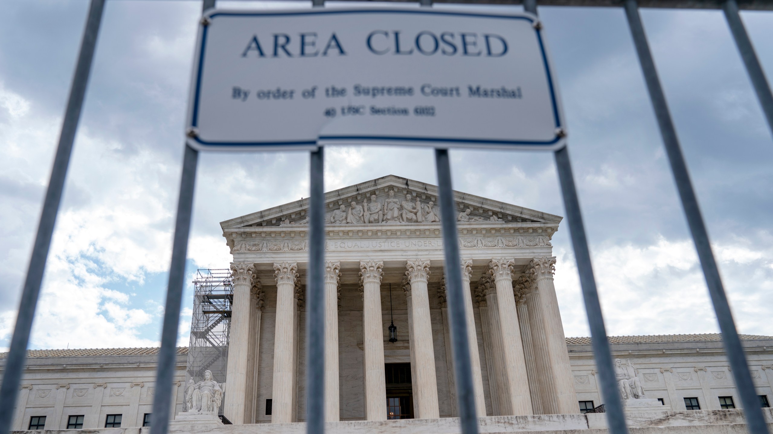 The Supreme Court is seen behind security fencing, Tuesday, June 27, 2023, in Washington, as decisions are expected. (AP Photo/Jacquelyn Martin)