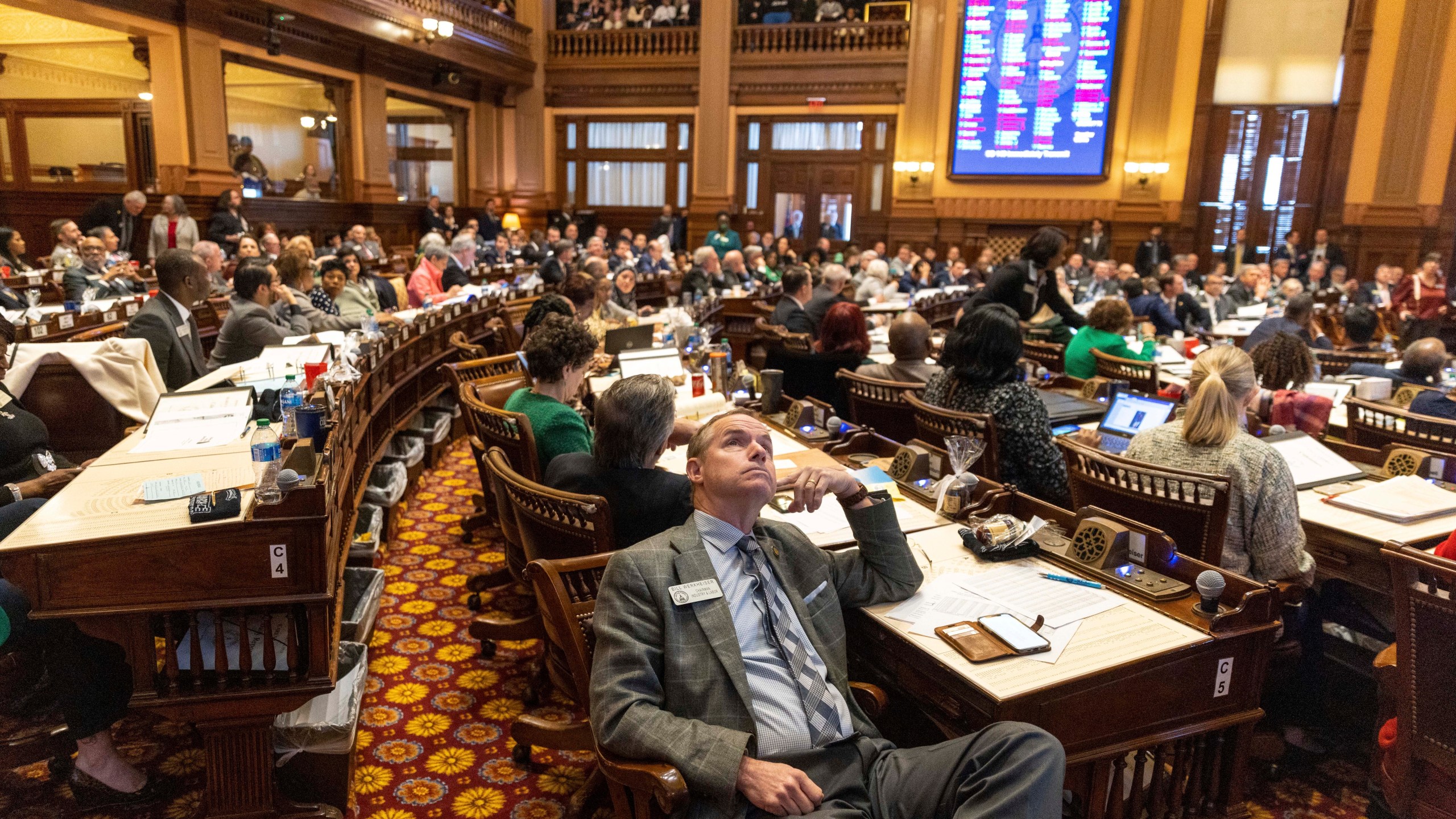 FILE - A view of the House of Representatives in Atlanta, following the passage of SB 140 on Thursday, March 16, 2023. SB 140 limits treatment for transgender youth. Lawyers for parents of four transgender children said they have filed a lawsuit challenging a Georgia law that bans most gender-affirming surgeries and hormone replacement therapies for transgender people under 18. The law is set to take effect Saturday, July 1. (Arvin Temkar/Atlanta Journal-Constitution via AP, File)