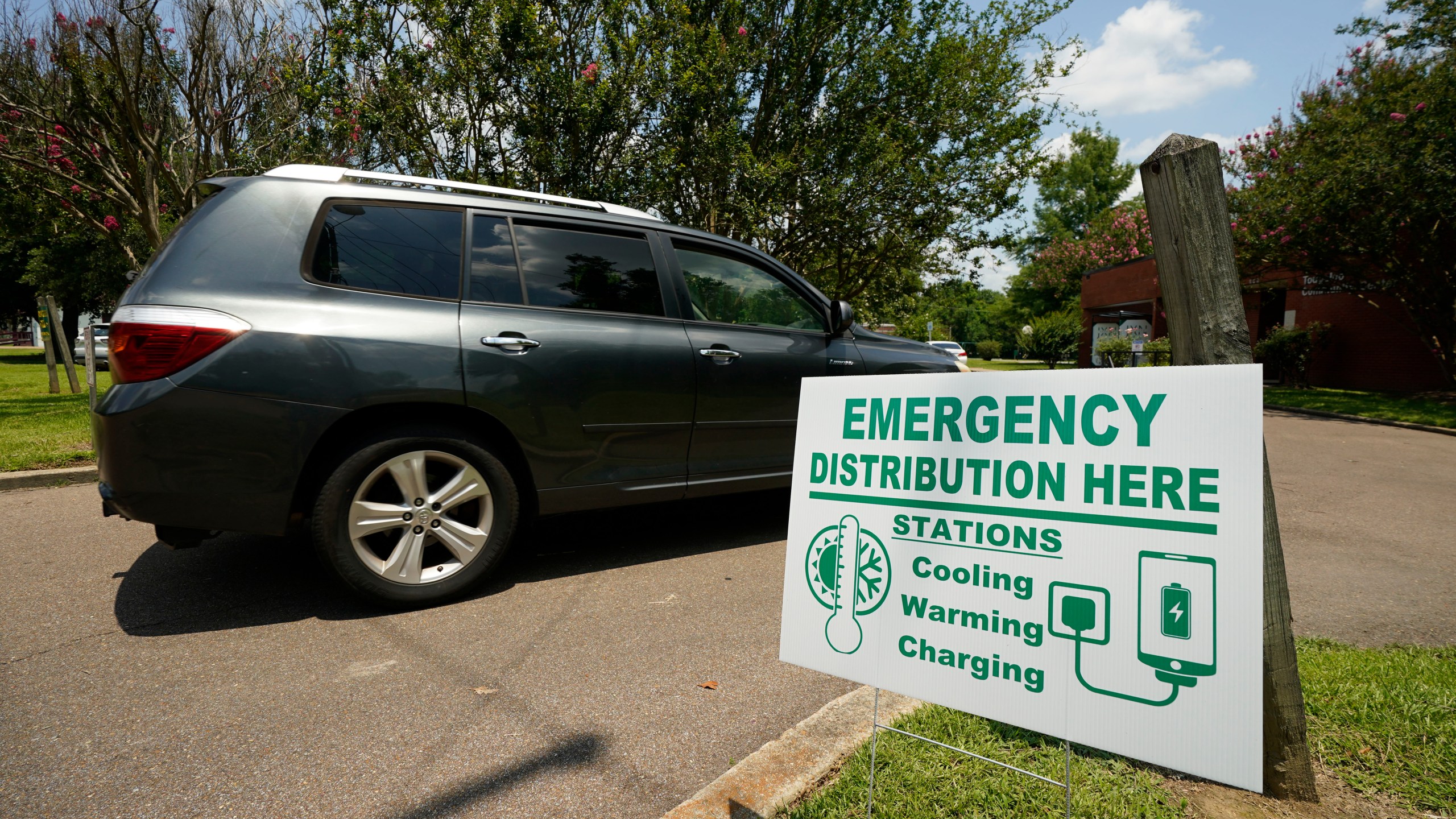 A Jackson, Miss., resident drives to the Tougaloo Community Center, Thursday, June 29, 2023, where the City of Jackson located one of six cooling centers. An oppressive heat wave blamed for at least 13 deaths in Texas and one in Louisiana is blanketing the South and the National Weather Service issued an excessive heat warning for parts of the Deep South on Friday, with a heat index expected to reach 115 degrees in several cities. (AP Photo/Rogelio V. Solis)