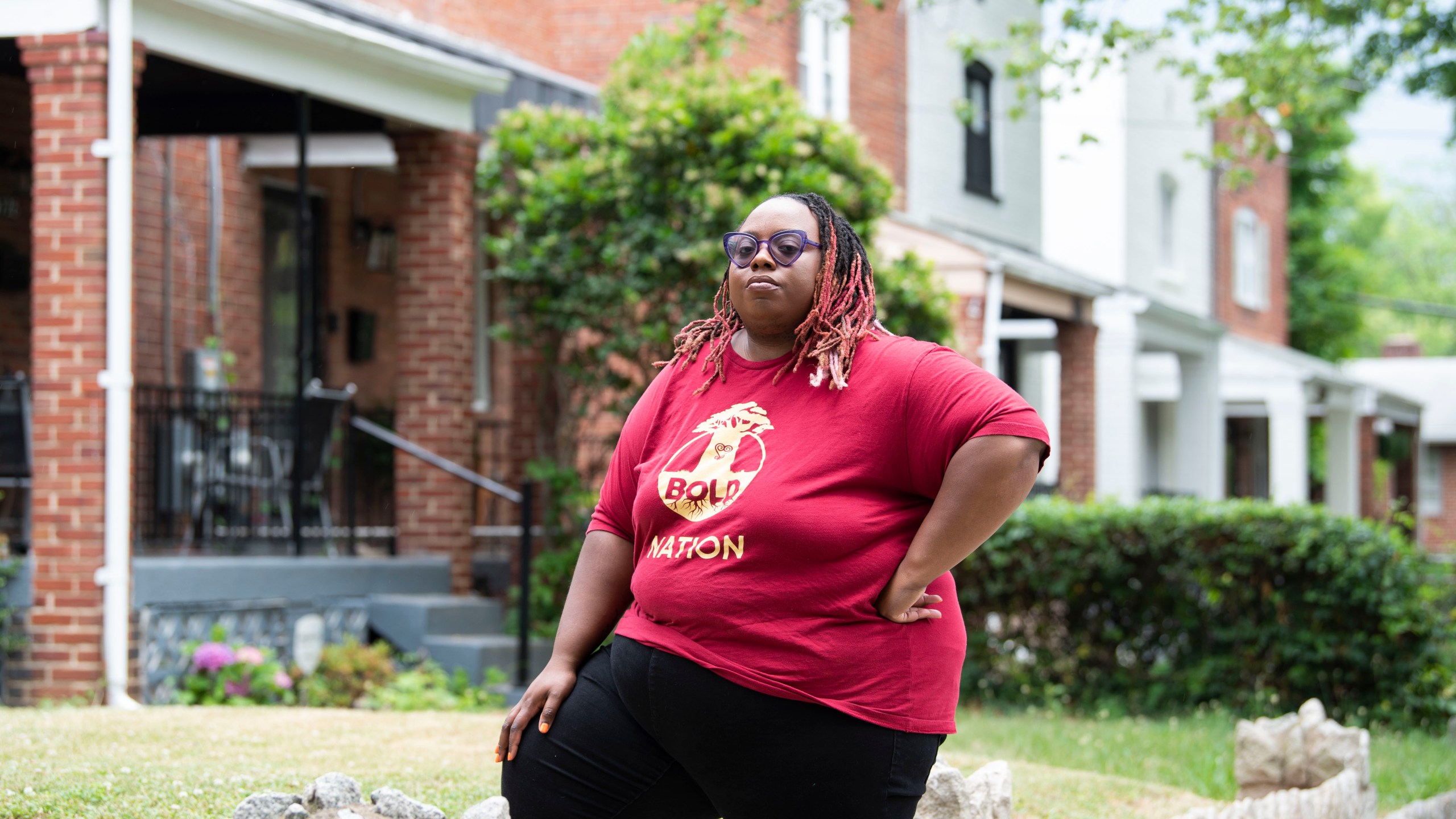 Makia Green stands outside her Washington home on June 12, 2023. As a Black student who was raised by a single mother, Green believes she benefited from a program that gave preference to students of color from economically disadvantaged backgrounds when she was admitted over a decade ago to the University of Rochester. As a borrower who still owes just over $20,000 on her undergraduate student loans, she has been counting on President Joe Biden's promised debt relief to wipe nearly all of that away. Now, both affirmative action and the student loan cancellation plan — policies that disproportionately help Black students — could soon be dismantled by the U.S. Supreme Court. (AP Photo/Kevin Wolf)