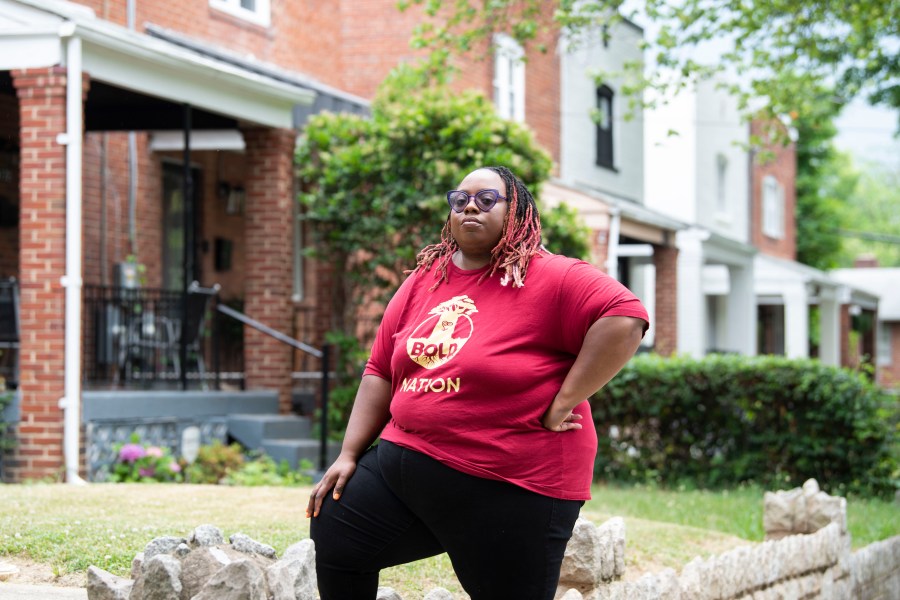 Makia Green stands outside her Washington home on June 12, 2023. As a Black student who was raised by a single mother, Green believes she benefited from a program that gave preference to students of color from economically disadvantaged backgrounds when she was admitted over a decade ago to the University of Rochester. As a borrower who still owes just over $20,000 on her undergraduate student loans, she has been counting on President Joe Biden's promised debt relief to wipe nearly all of that away. Now, both affirmative action and the student loan cancellation plan — policies that disproportionately help Black students — could soon be dismantled by the U.S. Supreme Court. (AP Photo/Kevin Wolf)