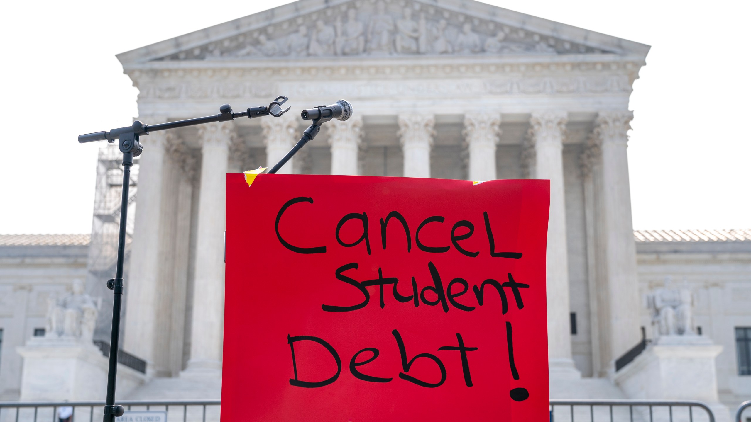 A sign reading "cancel student debt" is seen outside the Supreme Court, Friday, June 30, 2023, as decisions are expected in Washington. (AP Photo/Jacquelyn Martin)