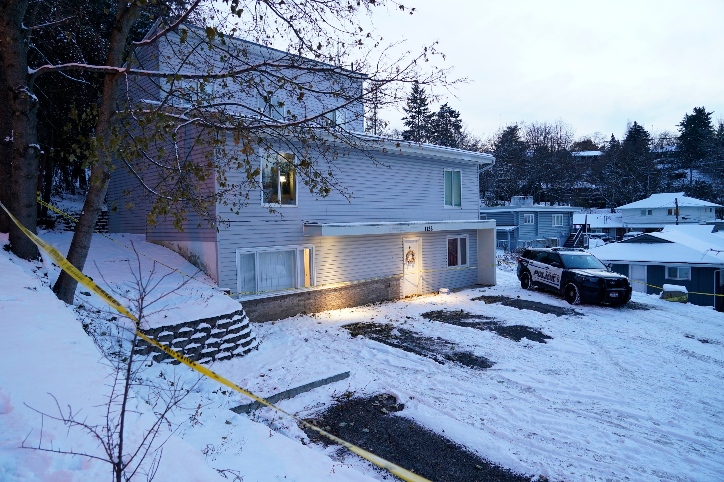 FILE - Bare spots are seen, Nov. 29, 2022, in the snowy parking lot in front of the home where four University of Idaho students were found dead on Nov. 13, in Moscow, Idaho, after vehicles belonging to the victims and others were towed away earlier in the day. Objections have been raised to demolishing the house where four University of Idaho students were killed in 2022, with members of three of the victims' families signaling it should be preserved until after the trial of the man charged in the deaths. (AP Photo/Ted S. Warren, File)