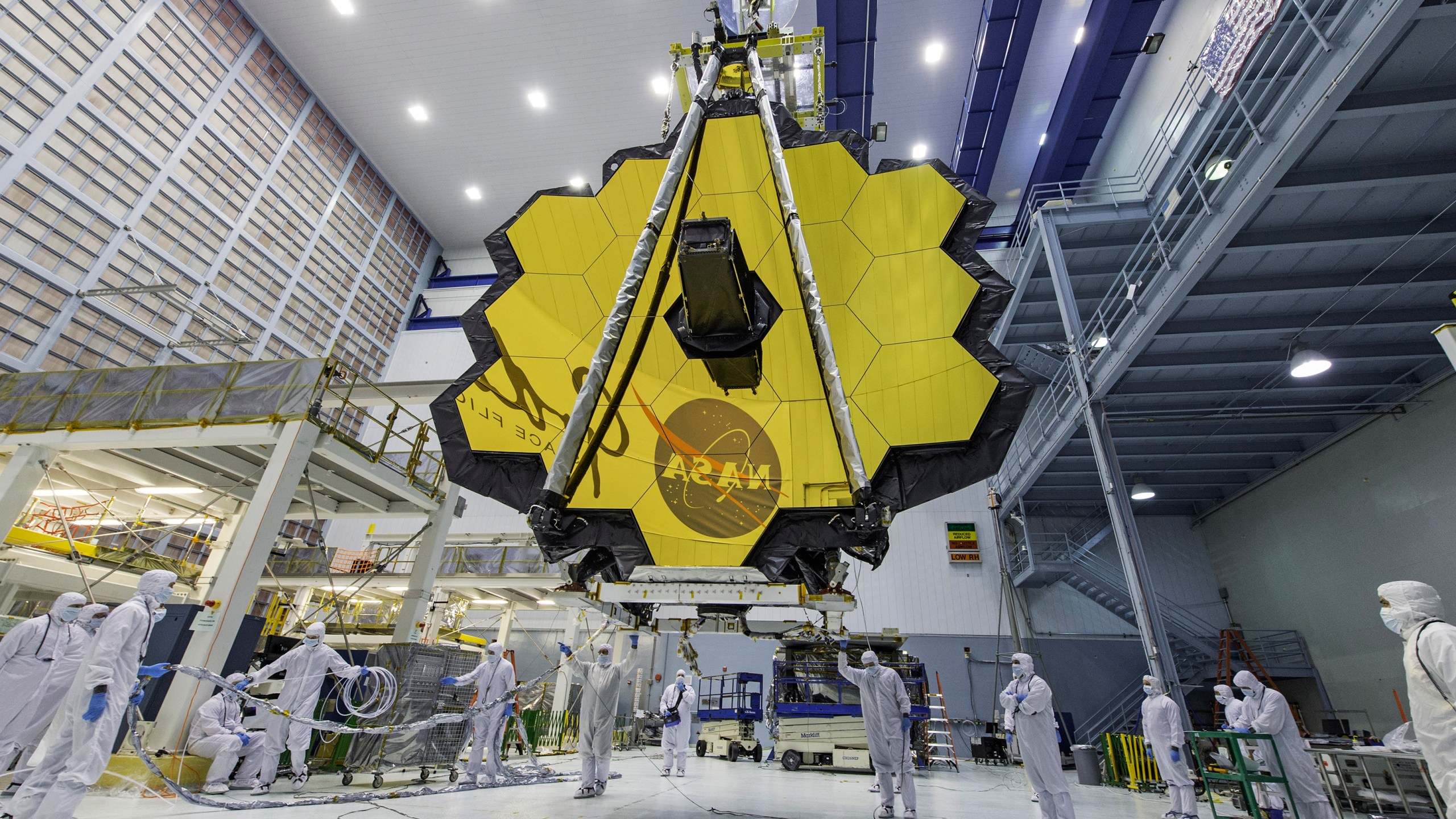 FILE - In this photo provided by NASA, technicians lift the mirror of the James Webb Space Telescope using a crane, April 13, 2017, at the Goddard Space Flight Center in Greenbelt, Md. Astronomers have discovered the most distant black hole yet using the Webb Space Telescope, but that record isn't expected to last. Webb already has spotted other black holes that appear to be even more distant, but those findings are still under review. (Laura Betz/NASA via AP, File)