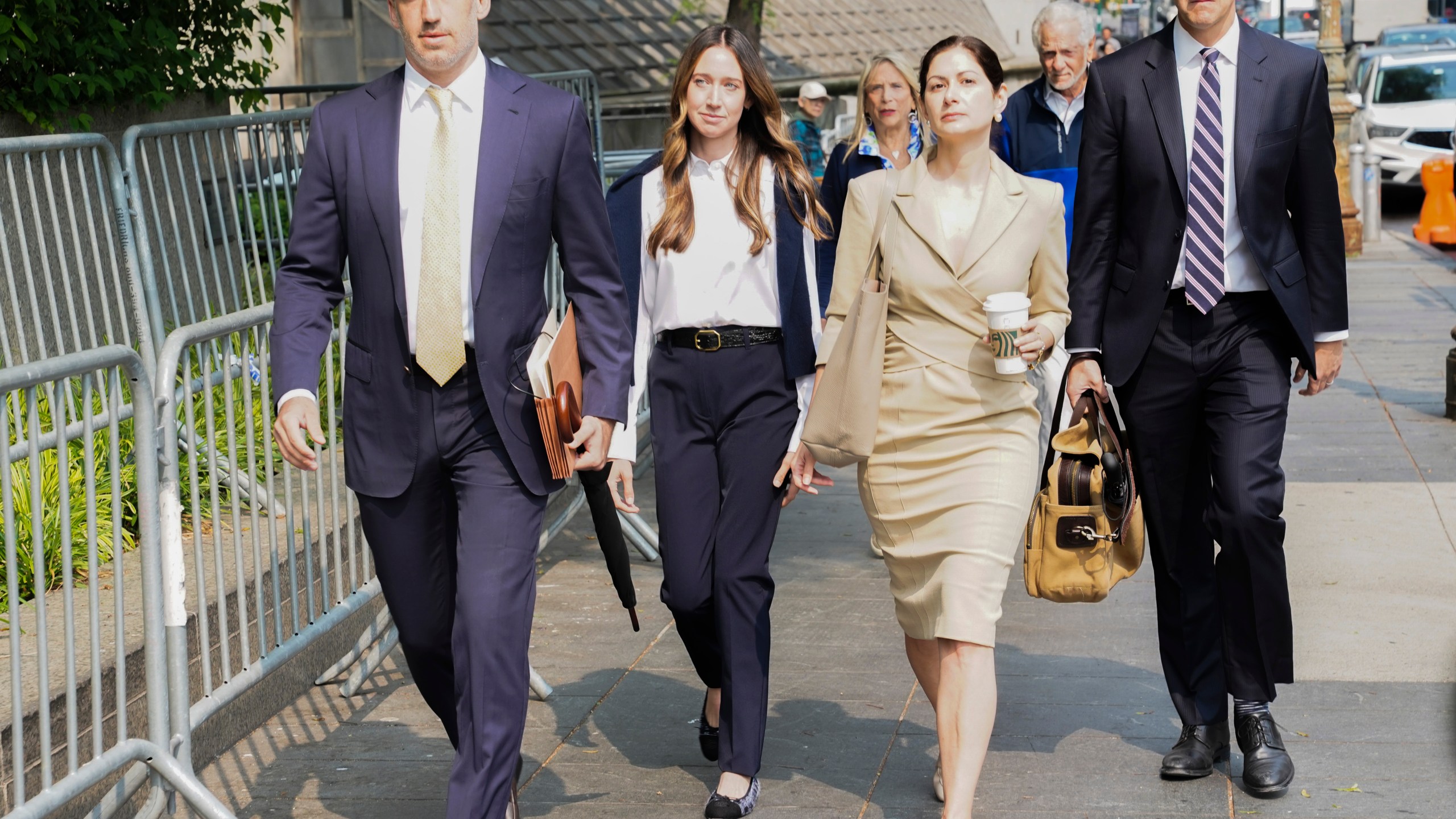 FILE - Charlie Javice, second from left, founder of a student loan assistance startup company charged with fraud, arrives at federal court with her legal team, June 6, 2023, in New York. Frank shook her head repeatedly Thursday, July 13, as a prosecutor claimed that she snookered J.P. Morgan Chase into paying $175 million for her business by lying about its client base. (AP Photo/Bebeto Matthews, File)