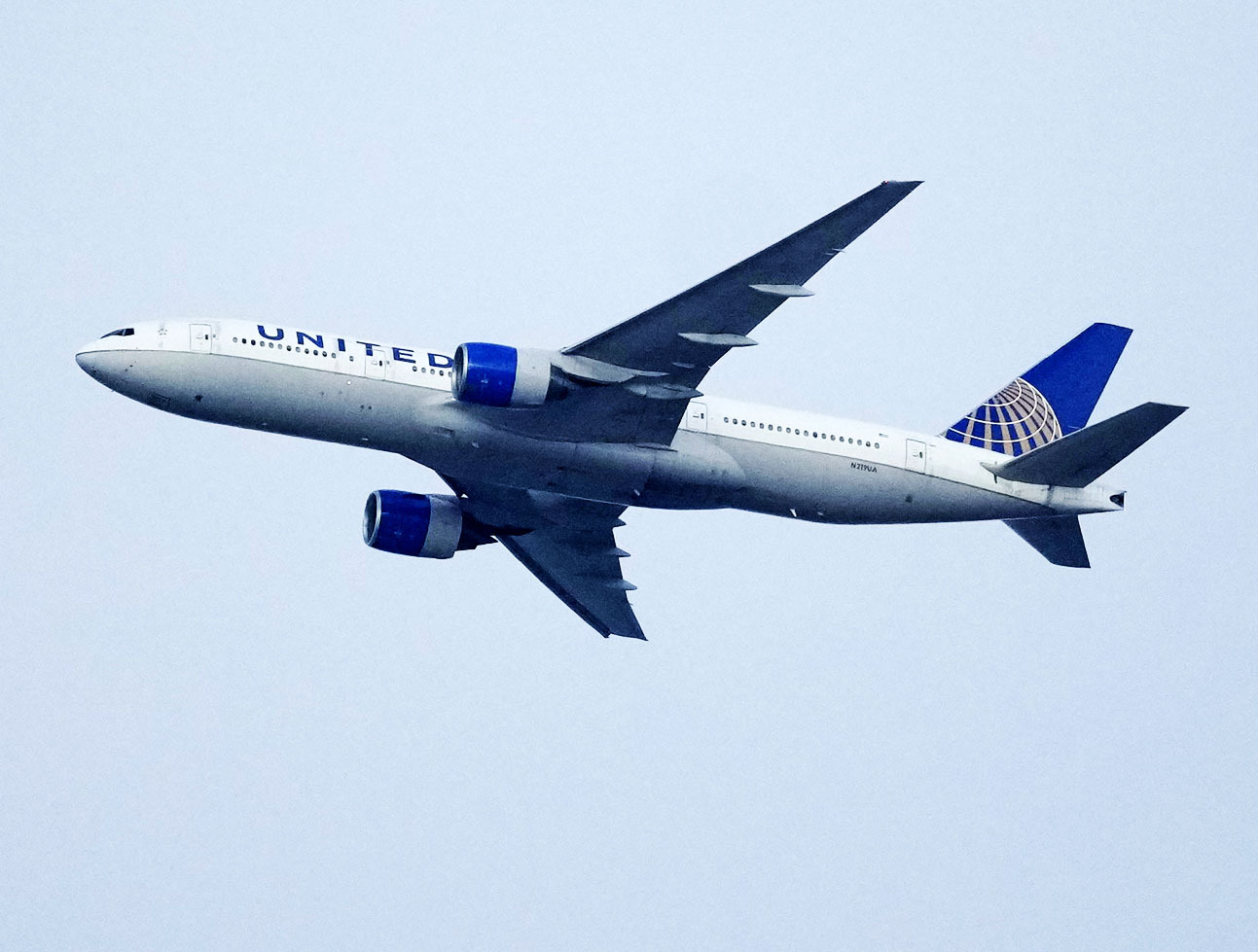 FILE - A United Airlines jetliner soars past an MLS soccer match July 8, 2023, in Commerce City, Colo. United Airlines and the union representing its pilots said Saturday, July 15, 2023, they reached agreement on a contract that will raise pilot pay by up to 40% over four years. (AP Photo/David Zalubowski, File)