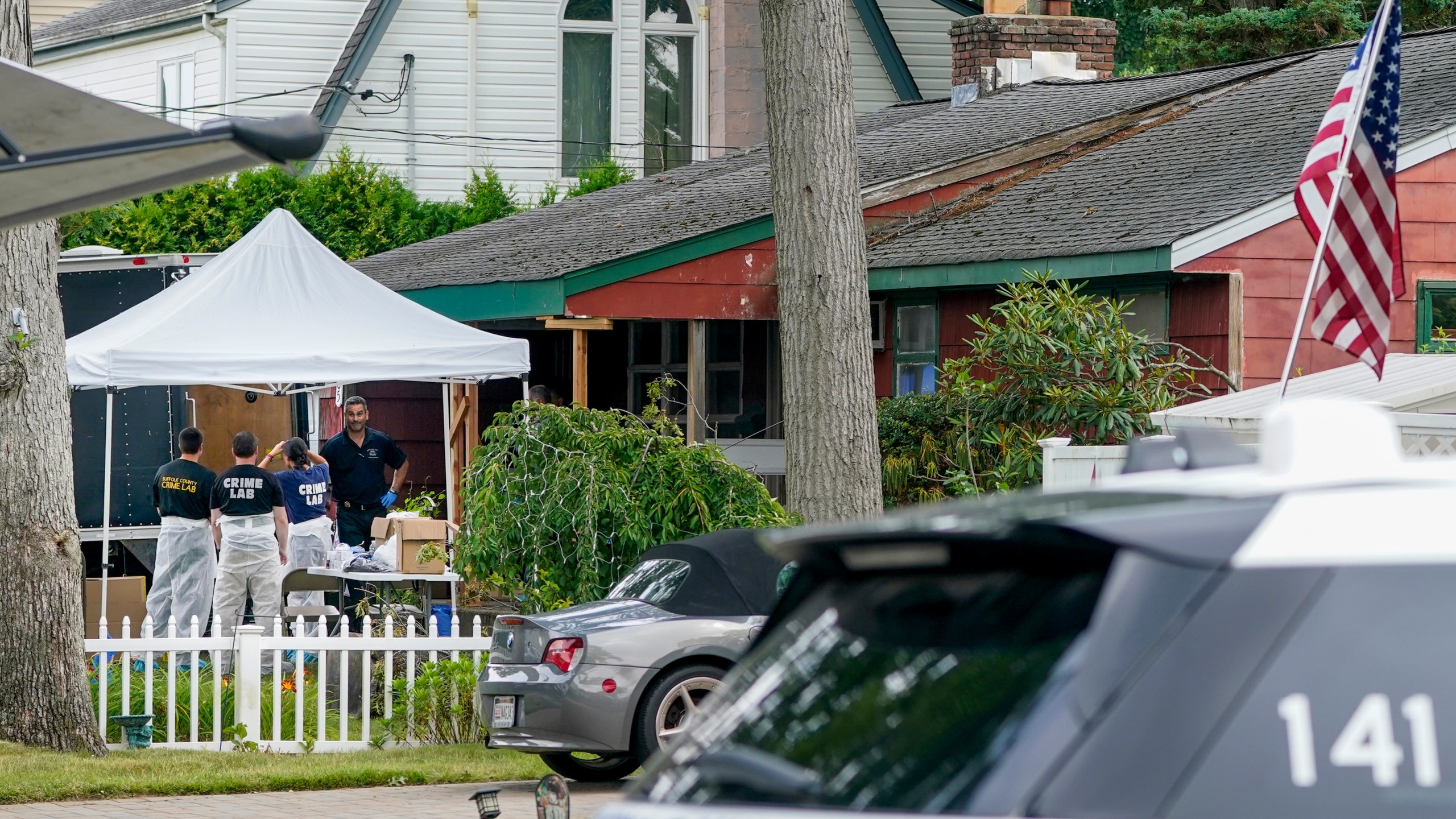 Authorities search the home of suspect Rex Heuermann, Tuesday, July 18, 2023, in Massapequa Park, N.Y. Detectives investigating the long-unsolved slayings known as the Gilgo Beach killings have continued their searches, recently including a storage facility in the Long Island community of Amityville over the weekend. (AP Photo/John Minchillo)