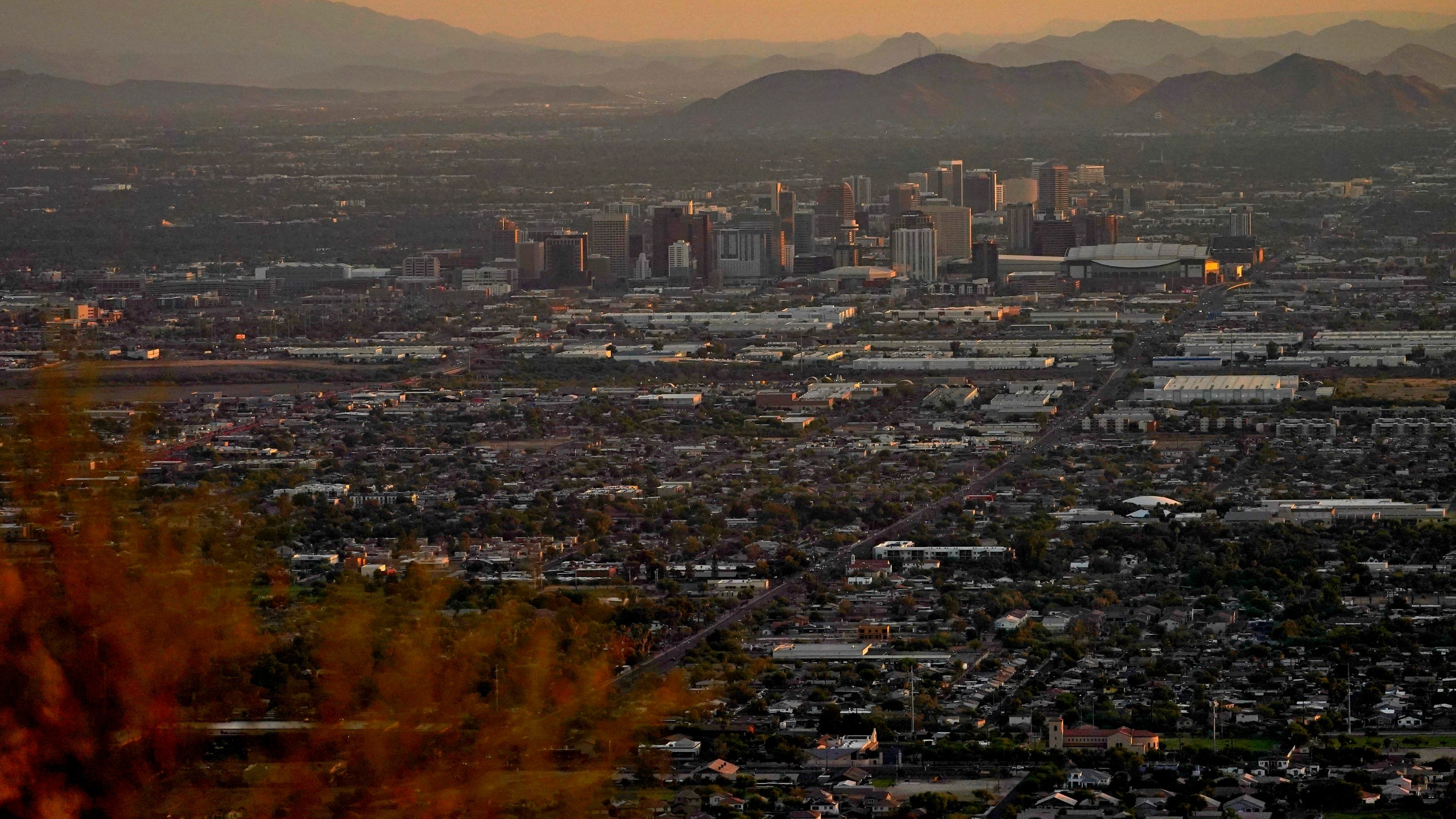 Day breaks over downtown Phoenix, Monday, July 17, 2023. Phoenix is set to break its own record for consecutive days of highs of at least 110 degrees. Around one-third of Americans are under some type of heat advisory, with the most blistering temperatures in the South and West, where even the regular simmer has turned up a notch. (AP Photo/Matt York)