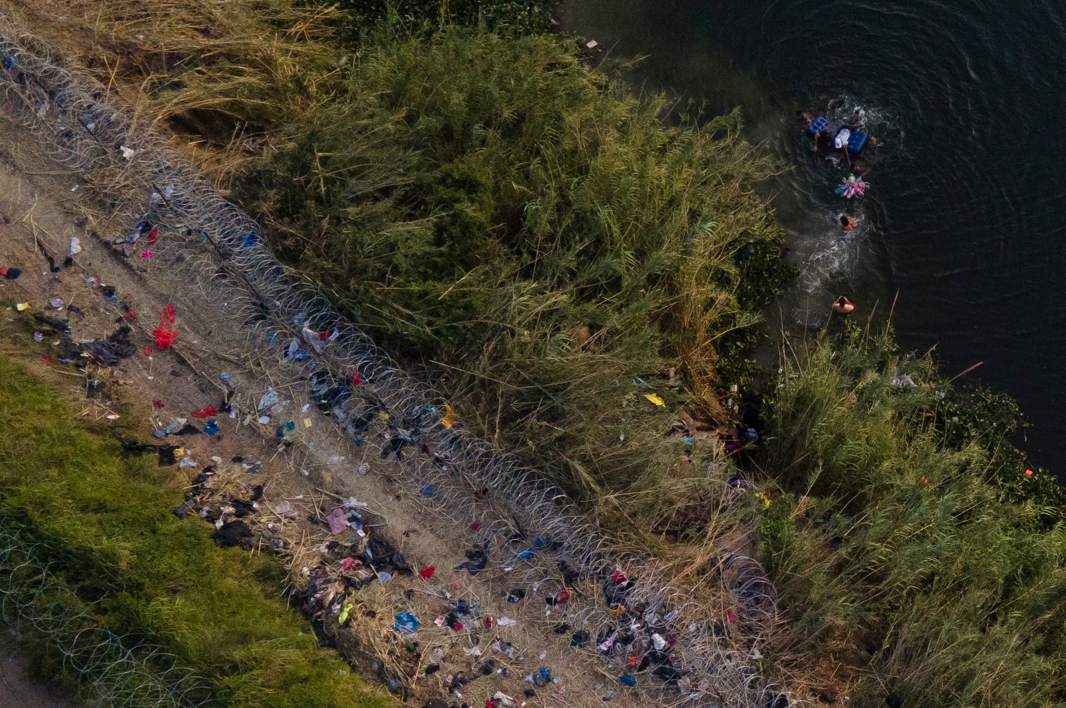 FILE - Migrants use a raft to cross the Rio Grande at the Texas-Mexico border, May 11, 2023, in Brownsville, Texas. Border Patrol does not have protocols for assessing medical needs of children with preexisting conditions, according to an independent report made public Tuesday, July 18, on the death of an 8-year-old girl from Panama who was in federal custody. (AP Photo/Julio Cortez, File)