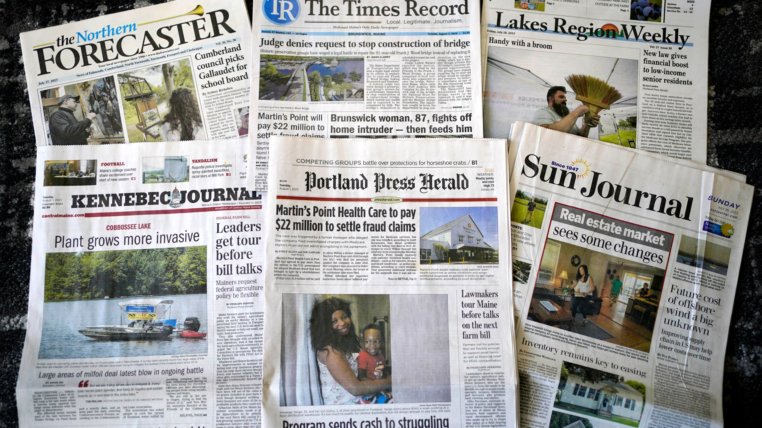 A sample of the Maine daily and weekly newspapers is seen, Tuesday, Aug. 1, 2023, in Augusta, Maine. The publications are part of a group of 20 newspapers formerly owned by Masthead Maine, the largest newspaper group in the state. The media network was sold to the nonprofit Maine Trust for Local News. (AP Photo/Robert F. Bukaty)