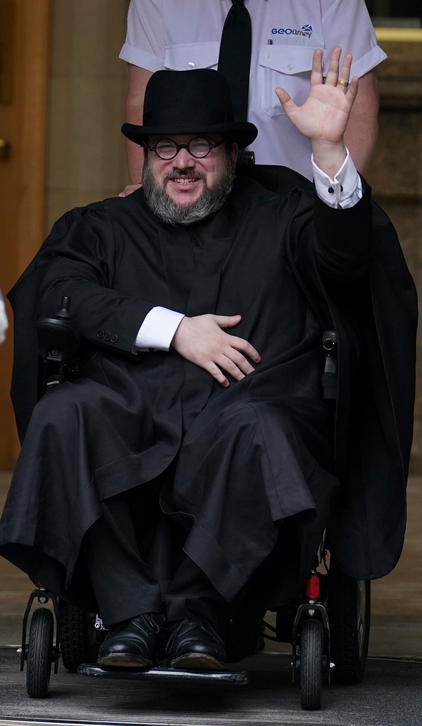 Nicholas Rossi from he U.S. waves as he leaves the Edinburgh Sheriff and Justice of the Peace Court in Edinburgh, Scotland, Wednesday, July 12, 2023. An American fugitive accused of faking his own death to avoid a rape charge has been ordered by a judge in Scotland to be returned to the U.S. The man known as Nicholas Rossi was ordered extradited Wednesday after fighting the case for nearly two years. (Andrew Milligan/PA via AP)