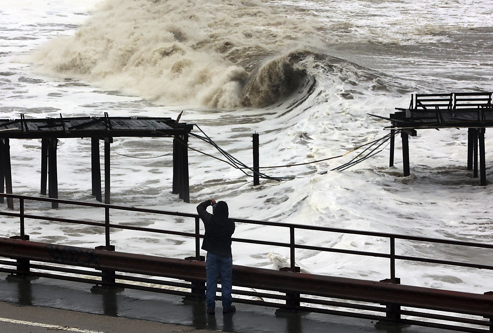 FILE - Powerful waves batter the Capitola Wharf after the storm destroyed a section of the structure on Jan. 5, 2023, in Capitola, Calif. Giant waves, measuring as high as 13 feet, are becoming more common off California's Pacific coast as the planet warms, according to new research that used a unique approach to gather historical data over the past 90 years to track the increasing height of the surf. (Shmuel Thaler/The Santa Cruz Sentinel via AP, File)