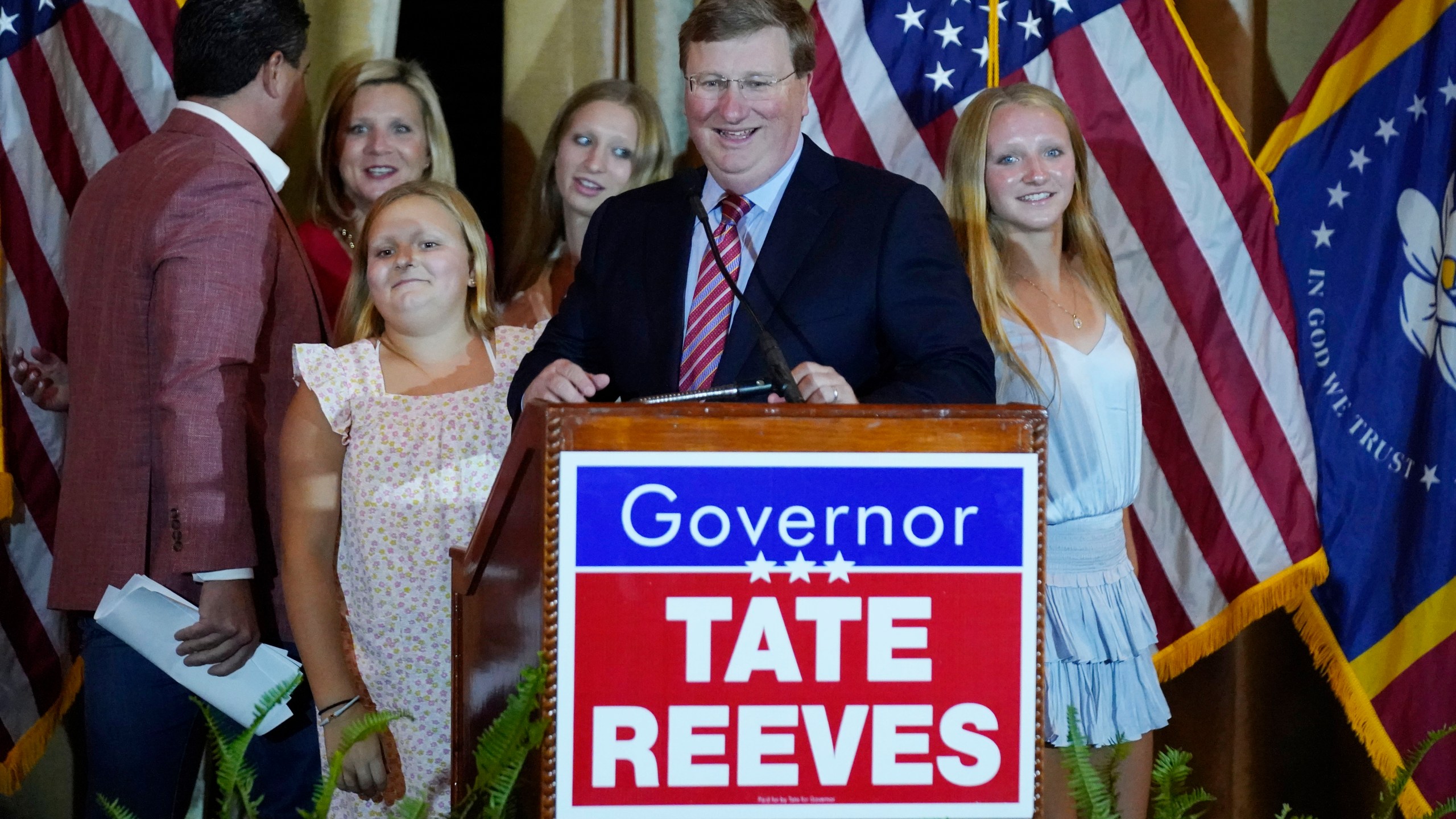 Republican Mississippi Gov. Tate Reeves leads his family to the podium to address supporters in Jackson, Miss., after winning the party primary Tuesday, Aug. 8, 2023. Reeves defeated two challengers for the party nomination. (AP Photo/Rogelio V. Solis)