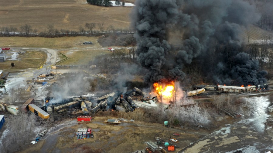 FILE - This photo taken with a drone shows portions of a Norfolk and Southern freight train that derailed Friday night in East Palestine, Ohio are still on fire at mid-day Saturday, Feb. 4, 2023. Regulators say Norfolk Southern has made improvements since a fiery Ohio derailment but still falls well short of being the “gold standard for safety” it is striving to be. The Federal Railroad Administration released a report on the railroad’s safety culture Wednesday, Aug. 9. (AP Photo/Gene J. Puskar, File)