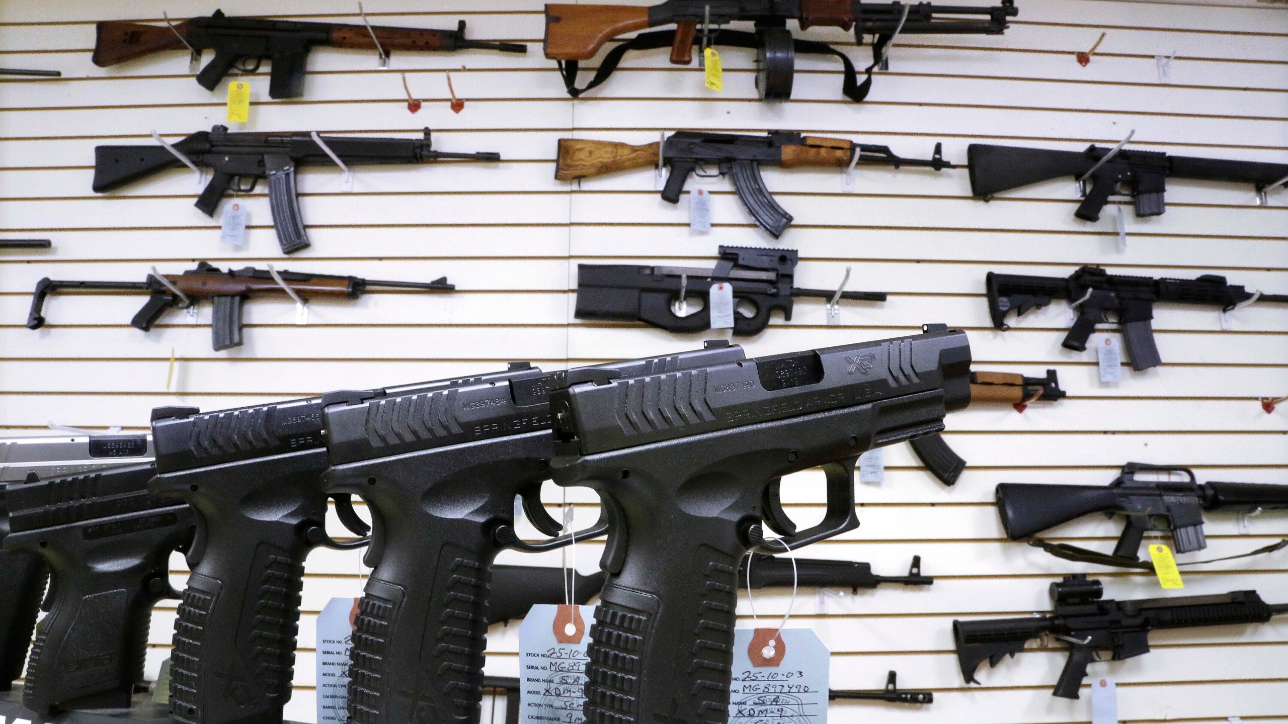 FILE - Assault weapons and hand guns are seen for sale at Capitol City Arms Supply on Jan. 16, 2013, in Springfield, Ill. The Illinois Supreme Court will issue an opinion on the state's ban on the sale or possession of semi-automatic weapons of the type used in the 2022 Independence Day shooting in the Chicago suburb of Highland Park that killed seven and dozens of other mass shootings nationally. Rep. Dan Caulkins, a Decatur Republican, and other gun owners of Macon County filed the lawsuit contending the law not only violates the Second Amendment but equal protection of the laws because it exempts police and military from the ban. (AP Photo/Seth Perlman, File)