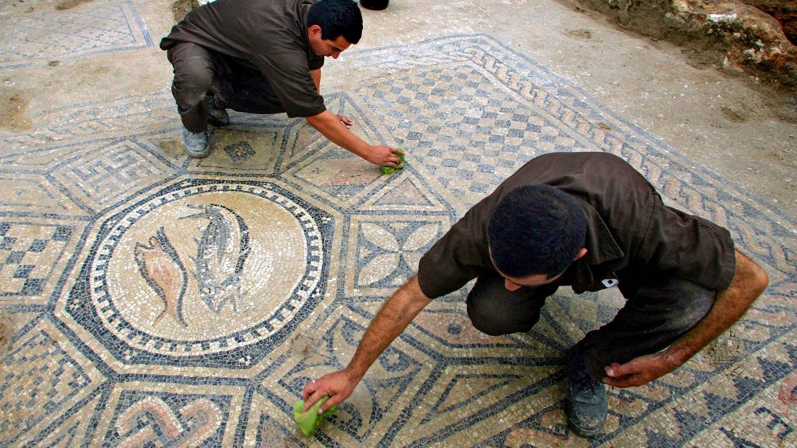 File - Prisoners work at a nearly 1,800-year-old decorated floor from an early Christian prayer hall discovered by Israeli archaeologists on Sunday, November 6, 2005 in the Megiddo prison. Israeli officials are considering uprooting the mosaic and loaning it to the controversial Museum of the Bible in Washington D.C., a proposal that has upset archaeologists and underscores the hardline government's close ties with evangelical Christians in the U.S. (AP Photo/Ariel Schalit, File)