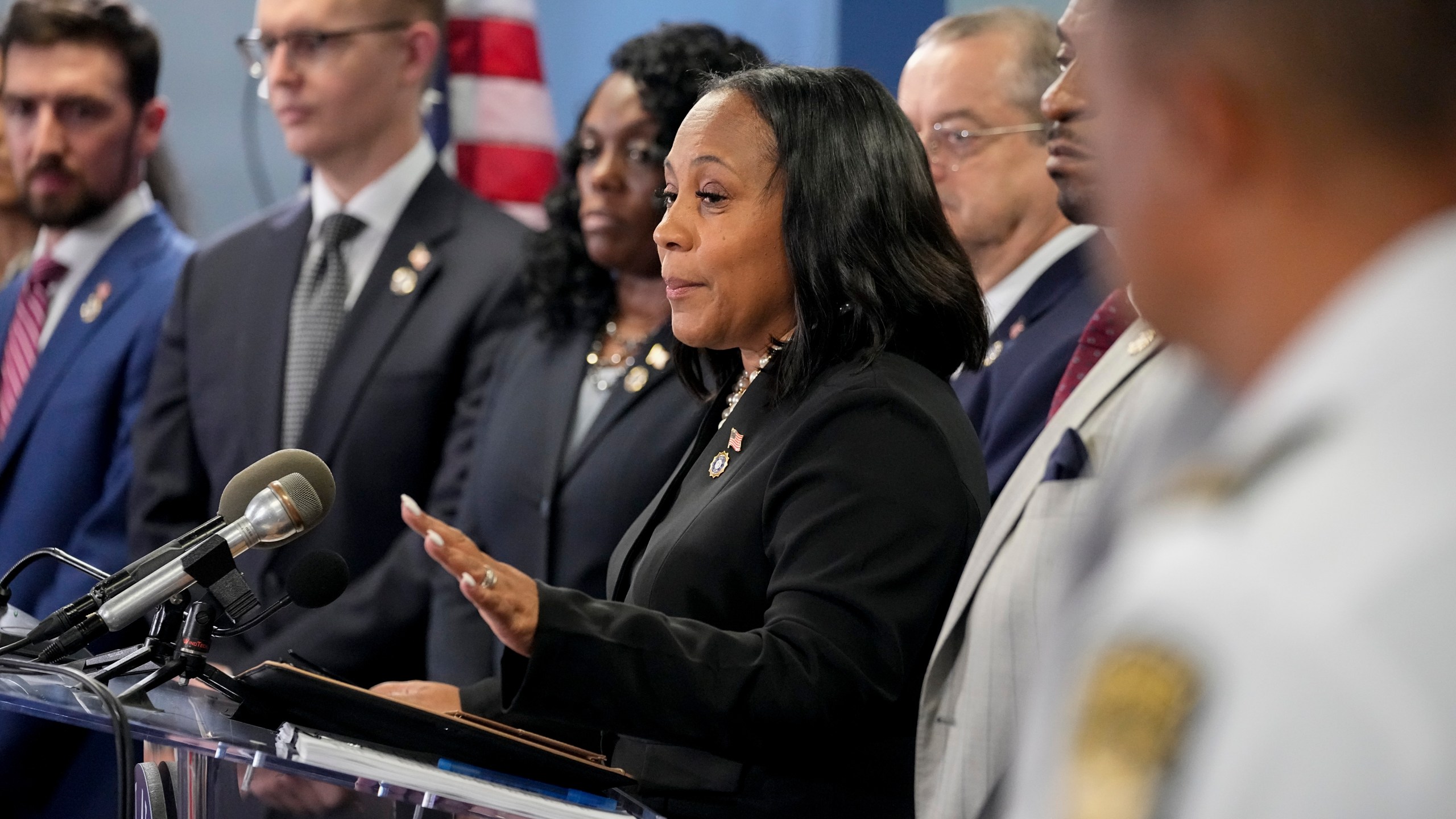 Fulton County District Attorney Fani Willis, center, speaks in the Fulton County Government Center during a news conference, Monday, Aug. 14, 2023, in Atlanta. Donald Trump and several allies have been indicted in Georgia over efforts to overturn his 2020 election loss in the state. (AP Photo/John Bazemore)