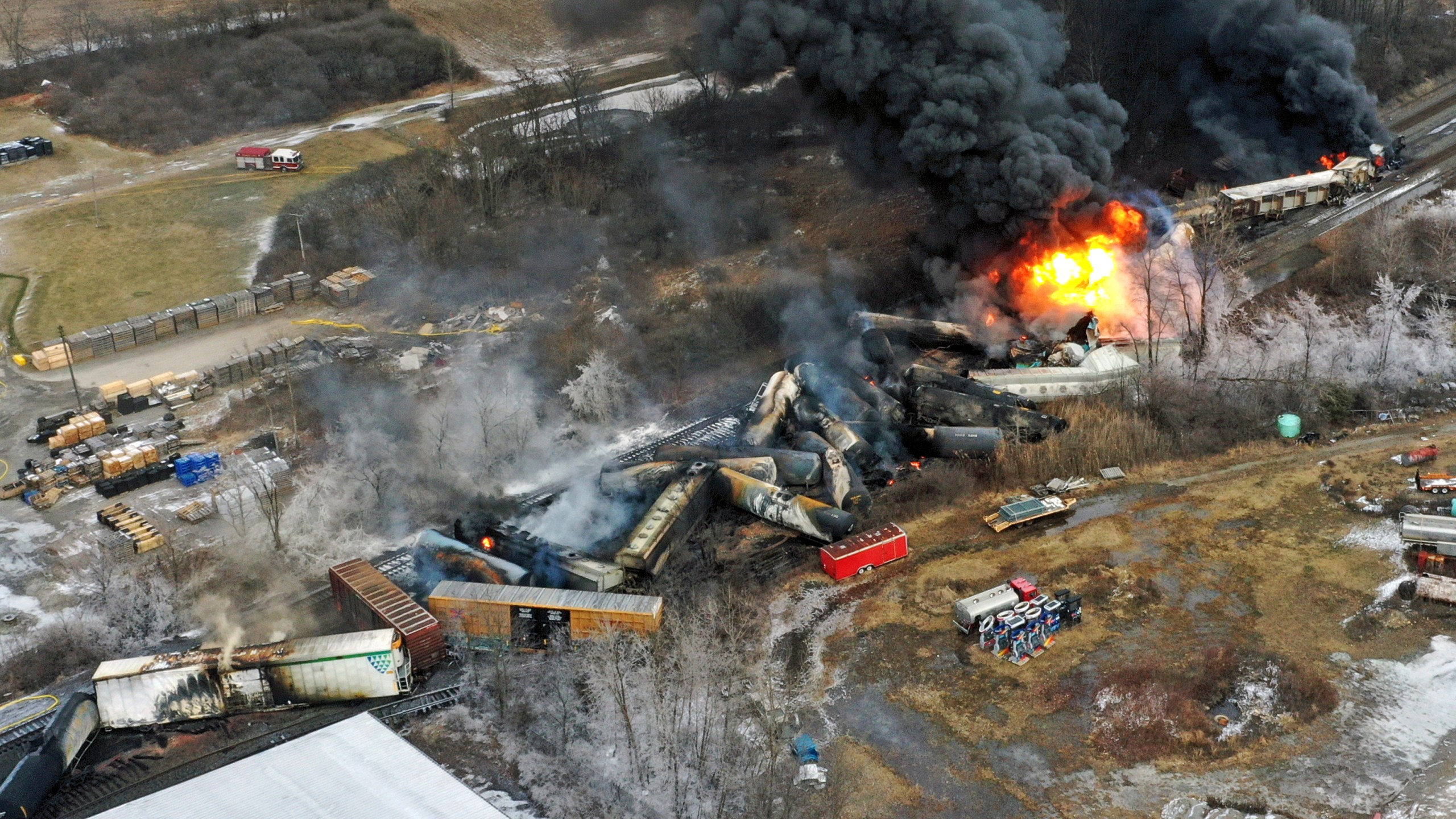 FILE - In this photo taken with a drone, portions of a Norfolk Southern freight train that derailed the previous night in East Palestine, Ohio, remain on fire at mid-day on Feb. 4, 2023. Lawyers and unions who represent rail workers say there is a clear pattern across the industry of railroads retaliating against workers who report safety violations or injuries on the job. (AP Photo/Gene J. Puskar, File)