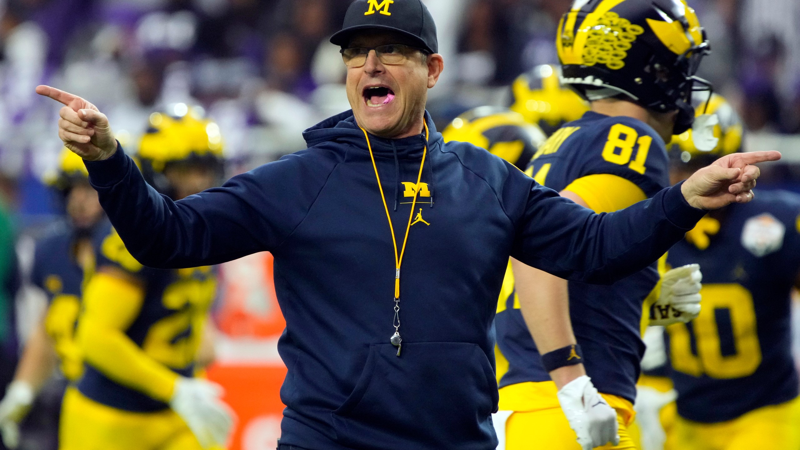 FILE - Michigan head coach Jim Harbaugh gestures during the first half of the Fiesta Bowl NCAA college football semifinal playoff game against TCU, Saturday, Dec. 31, 2022, in Glendale, Ariz. Michigan faces Ohio State on Nov. 25, 2023. This becomes huge if both the Buckeyes and Wolverines get past Big Ten title contender No. 7 Penn State. (AP Photo/Rick Scuteri, File)