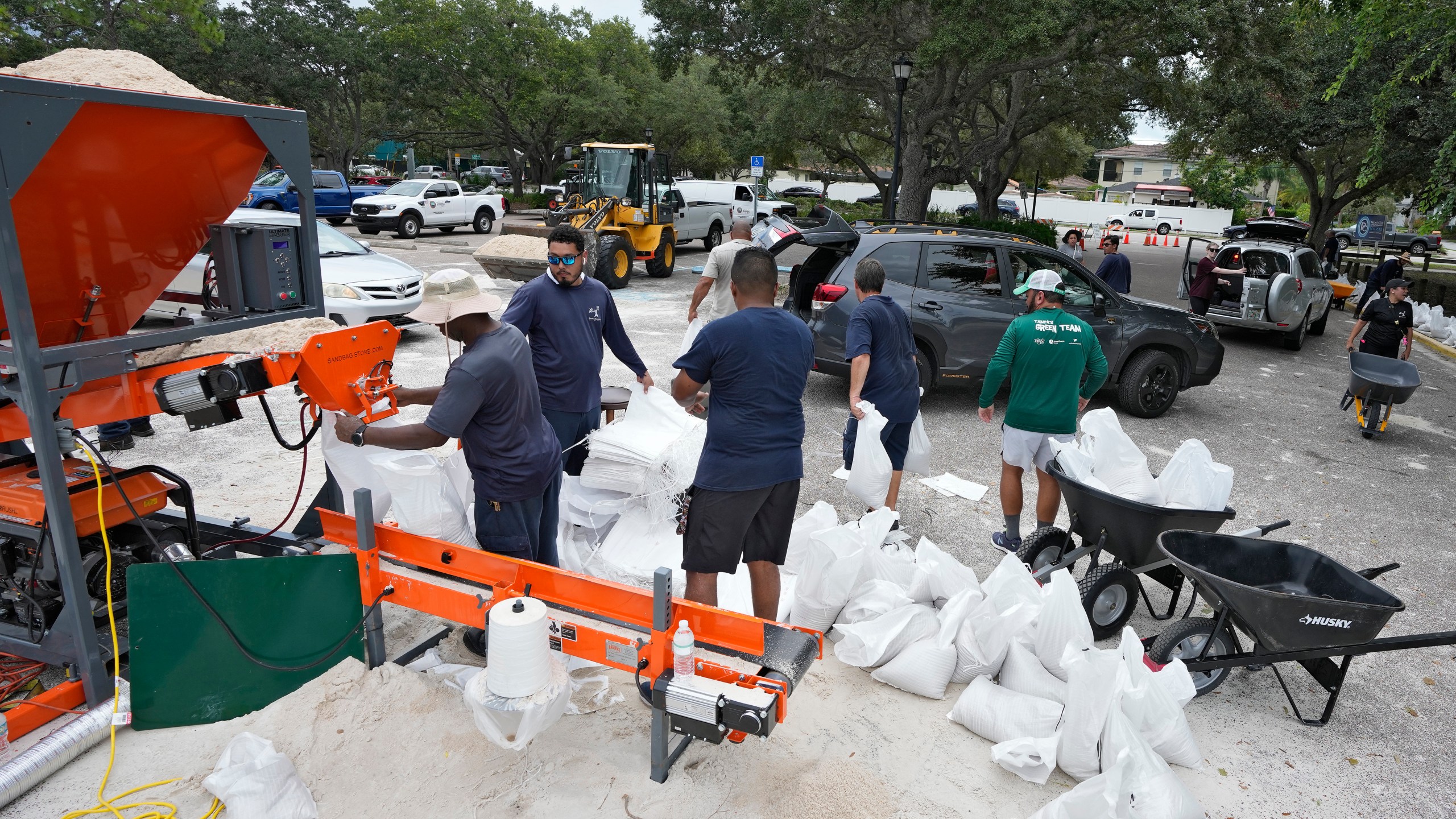 Members of the Tampa, Fla., parks and Recreation Dept., help residents with sandbags Monday, Aug. 28, 2023, in Tampa, Fla. Residents along Florida's gulf coast are making preparations for the effects of Tropical Storm Idalia. (AP Photo/Chris O'Meara)