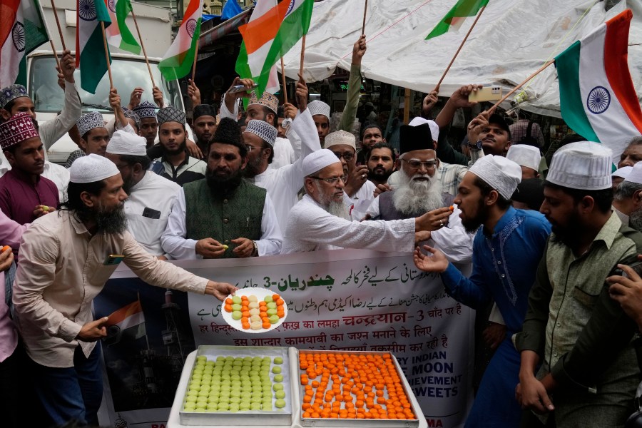 Indians distribute sweets to celebrate the success of Chandrayaan - 3 soft landing on the moon, in Mumbai, India, Wednesday, Aug. 23, 2023.(AP Photo/Rajanish Kakade)