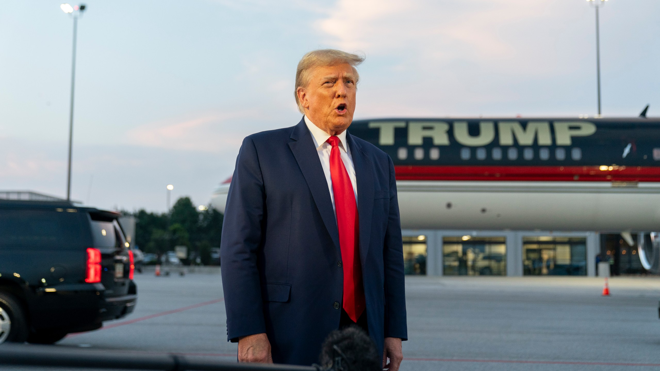 FILE - Former President Donald Trump speaks with reporters before departure from Hartsfield-Jackson Atlanta International Airport, Thursday, Aug. 24, 2023, in Atlanta. Trump has pleaded not guilty and waived arraignment in the case accusing him and others of illegally trying to overturn the results of the 2020 election in Georgia. (AP Photo/Alex Brandon, File)