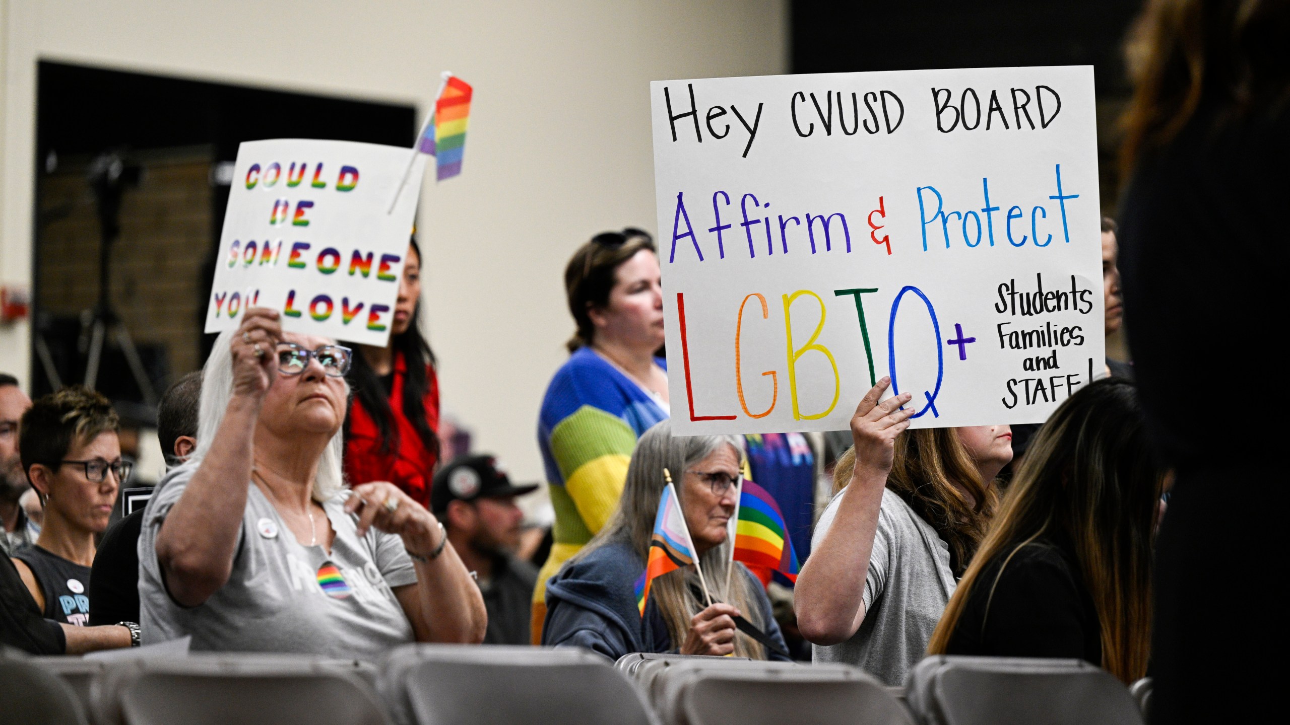 Parents, students, and staff of Chino Valley Unified School District hold up signs in favor of protecting LGBTQ+ policies at Don Antonio Lugo High School, on Thursday, June 15, 2023. California's attorney general has sued a Southern California school district over its new policy that requires schools to notify parents if their children change their gender identification or pronouns. Attorney General Rob Bonta announced the suit Monday, Aug. 28, against Chino Valley Unified School District. (Photo by Anjali Sharif-Paul/The Orange County Register via AP)