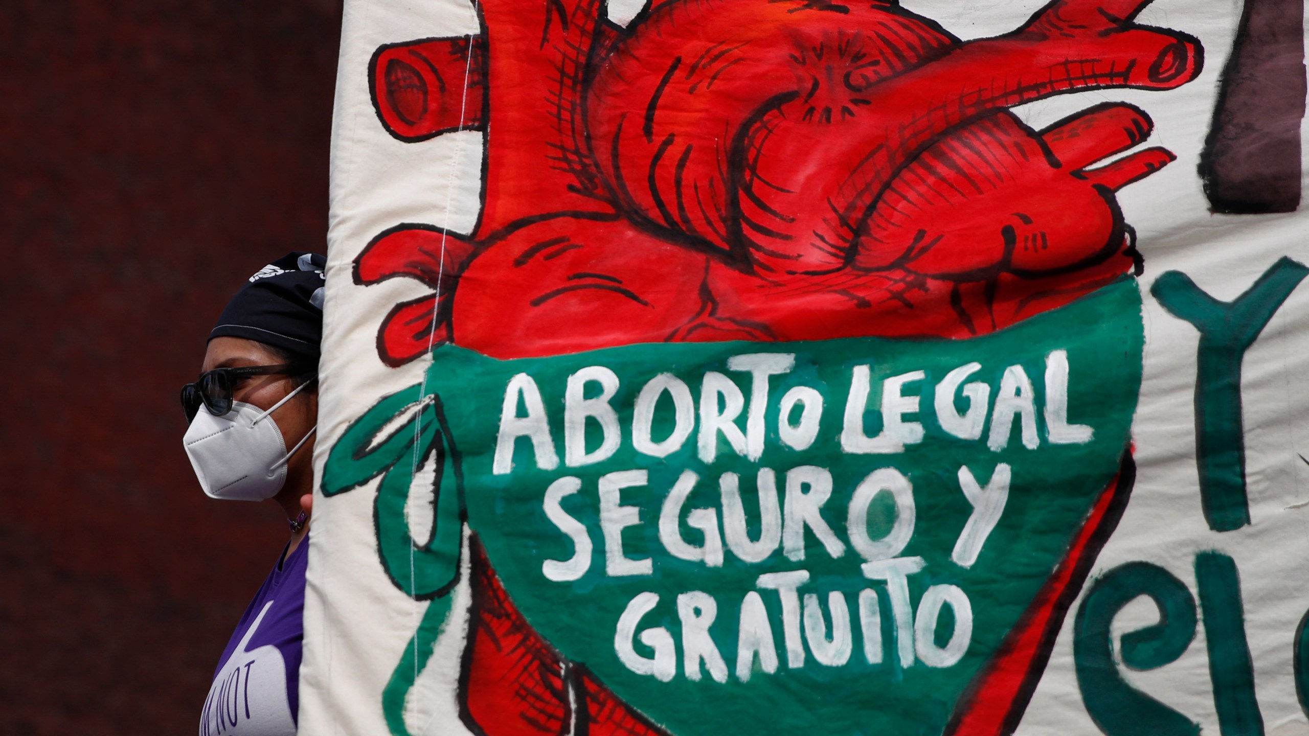 FILE - A woman holds a banner reading in Spanish, "Legal, safe, and free abortion" as abortion rights protesters demonstrate in front of the National Congress on the "Day for Decriminalization of Abortion in Latin America and the Caribbean," in Mexico City, Sept. 28, 2020. Mexico’s Supreme Court on Wednesday, Sept. 6, 2023, has decriminalized abortion nationwide. (AP Photo/Rebecca Blackwell, File)