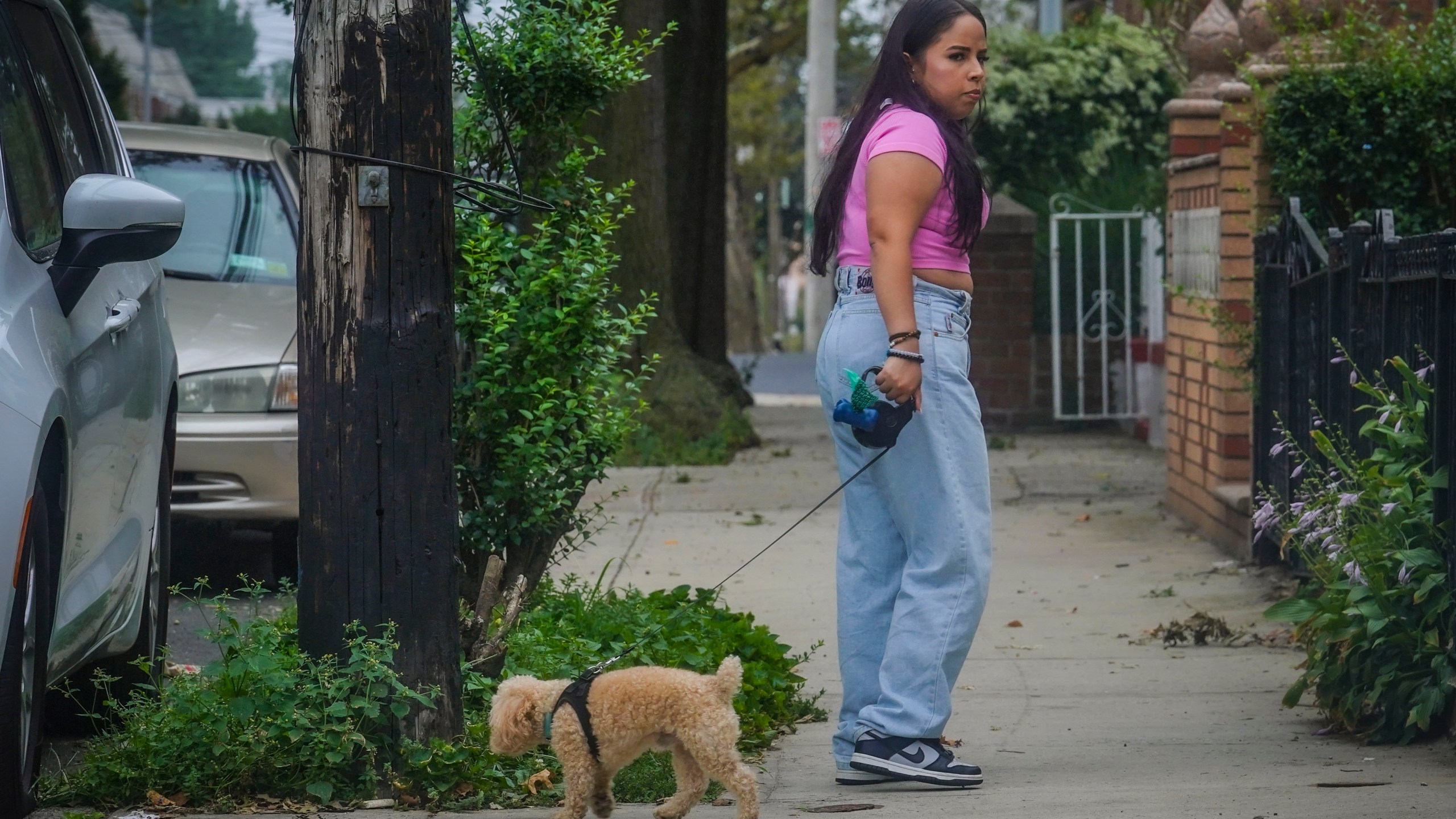 Melissa Chavez walks her toy poodle Milo, Thursday, Aug. 24, 2023, in New York. When Chavez decided to get a dog in the summer of 2020, she had an idea of the costs but was surprised by how fast they added up.(AP Photo/Bebeto Matthews)