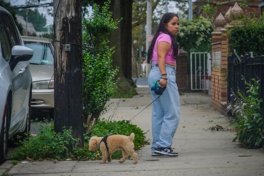 Melissa Chavez walks her toy poodle Milo, Thursday, Aug. 24, 2023, in New York. When Chavez decided to get a dog in the summer of 2020, she had an idea of the costs but was surprised by how fast they added up.(AP Photo/Bebeto Matthews)