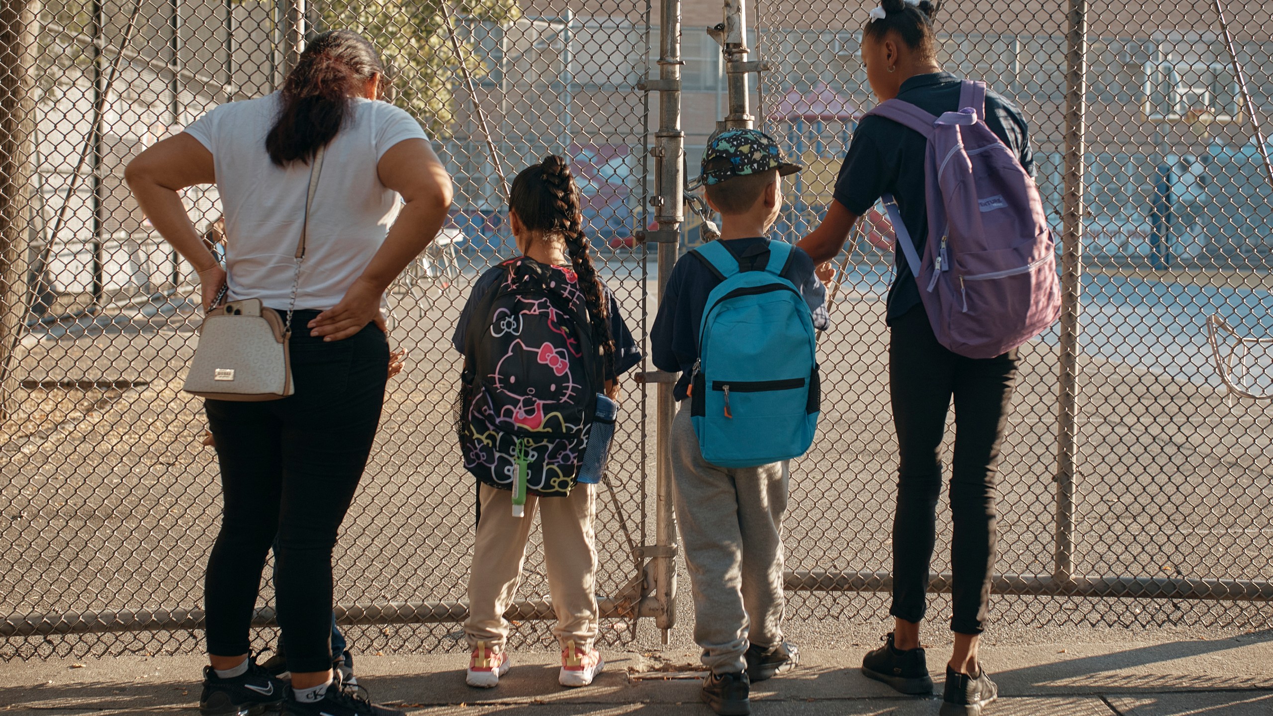 Damien Salinas, 5 years old, center right, arrives to school on Thursday, Sept. 7, 2023, in New York. Damien attends his first day of school in New York City after his family emigrated from Ecuador in June. Damien and her family have been living in a room at the historic Roosevelt Hotel, converted into a city-run shelter for newly arrived migrant families hoping to find work, a new home and a better life for their children. (AP Photo/Andres Kudacki)