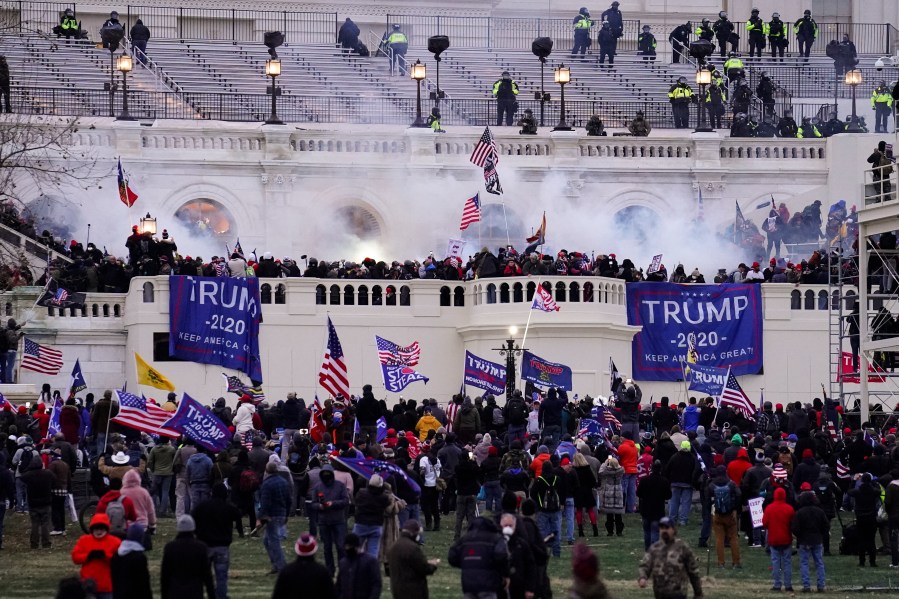 FILE - Violent rioters loyal to President Donald Trump storm the Capitol in Washington on Jan. 6, 2021. Leo Brent Bozell IV, 44, of Palmyra, Pa., the son of a prominent conservative activist, has been convicted of charges that he stormed the U.S. Capitol on Jan. 6, 2021, bashed in a window, chased a police officer, invaded the Senate floor and helped a mob disrupt the certification of Democrat Joe Biden's presidential election victory. Bozell was found guilty Friday, Sept. 8, 2023, of 10 charges, according to a Justice Department news release. (AP Photo/John Minchillo, File)