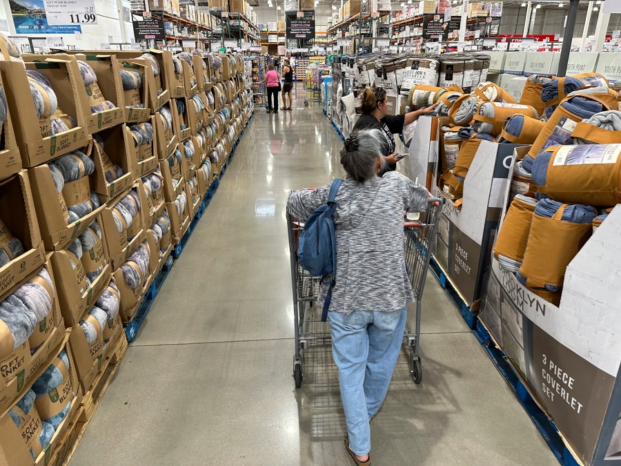 Shoppers look at blankets on sale in a Costco warehouse Thursday, Aug. 24, 2023, in Sheridan, Colo. On Wednesday, the Labor Department issues its consumer prices report for August. (AP Photo/David Zalubowski)