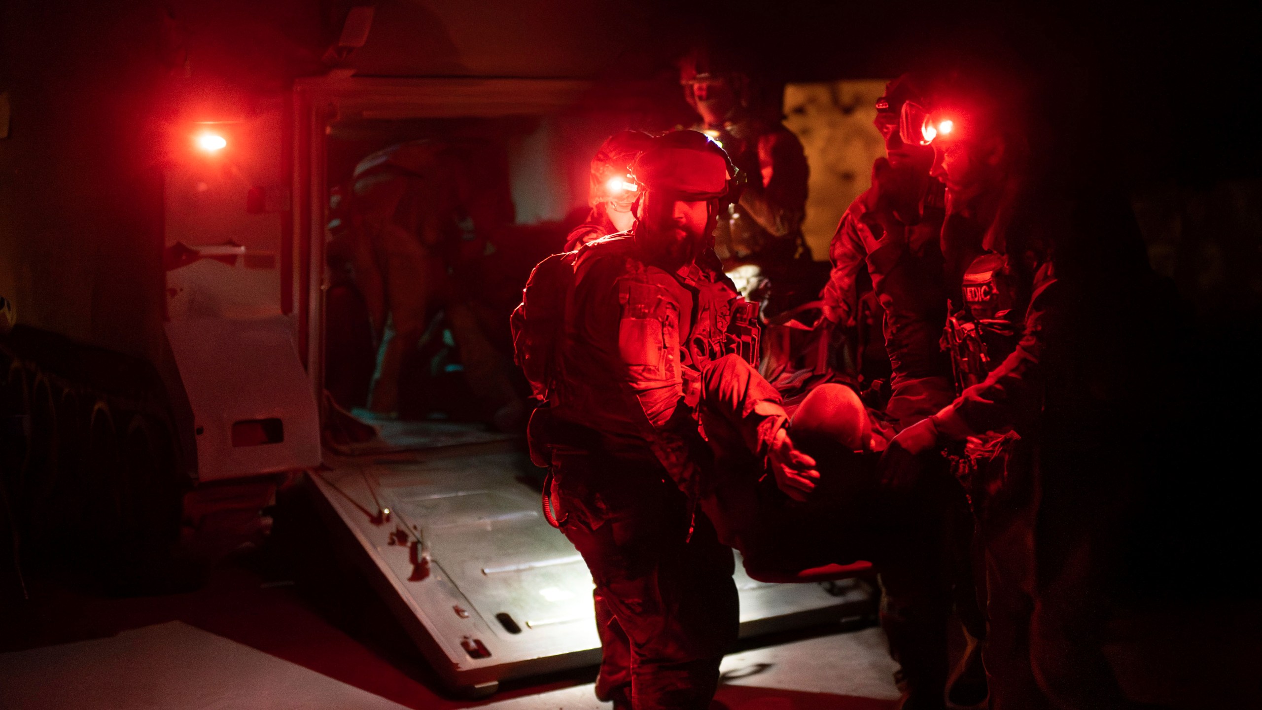 Ukrainian paramedics from 3rd Assault brigade carry on a stretcher their wounded comrade from an APC to the evacuation ambulance near Bakhmut, Donetsk region, Ukraine, Tuesday Sept. 12, 2023. (AP Photo/Alex Babenko)