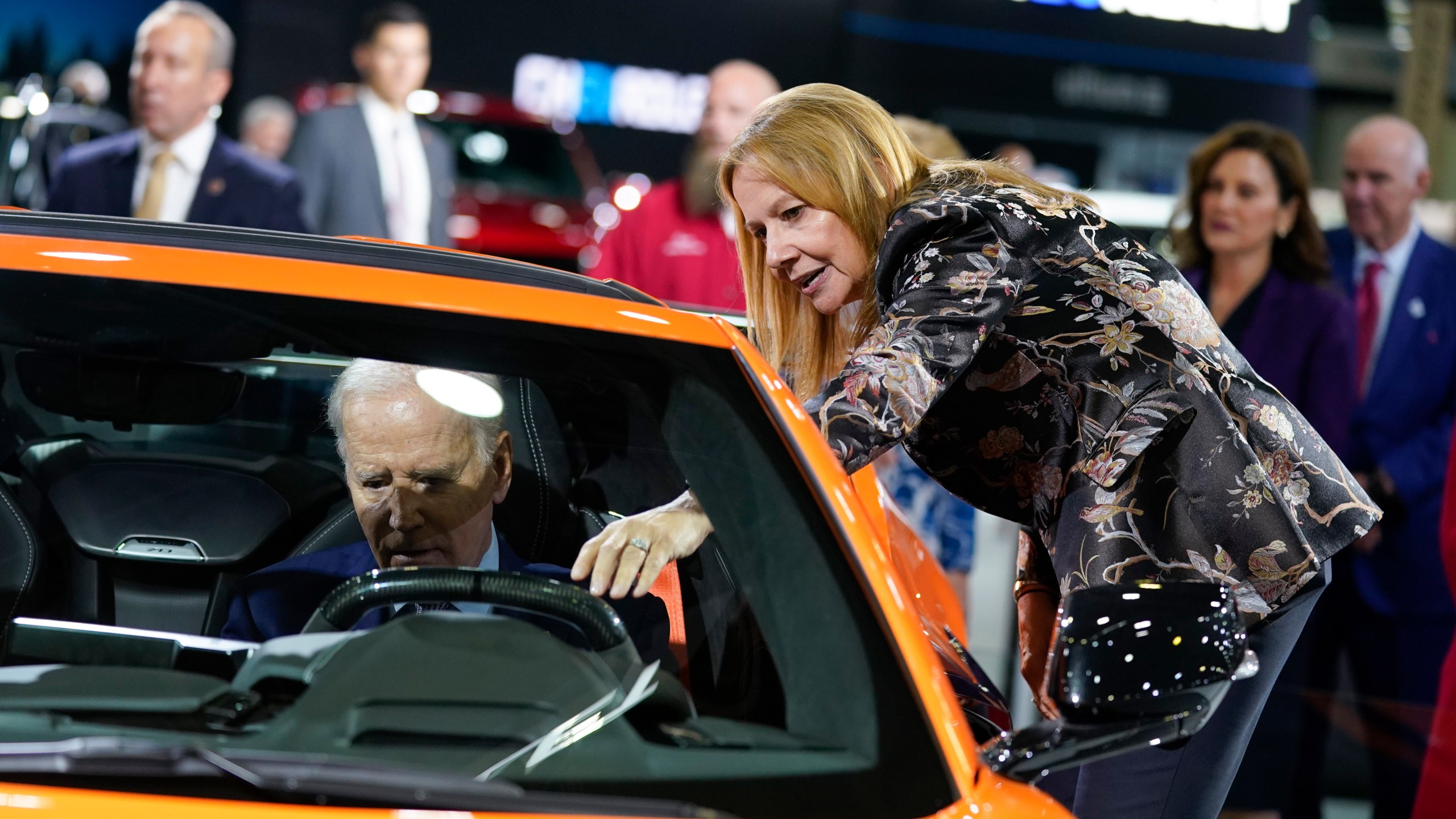 File - Mary Barra, CEO of General Motors, talks with President Joe Biden as he sits in a Corvette during a tour of the Detroit Auto Show on Sept. 14, 2022, in Detroit. United Auto Workers President Shawn Fain's focus on CEO pay is part of a growing trend as emboldened labor unions cite the widening wealth gap between workers and the top bosses to bolster their demand for higher wages and better working conditions. (AP Photo/Evan Vucci, File)