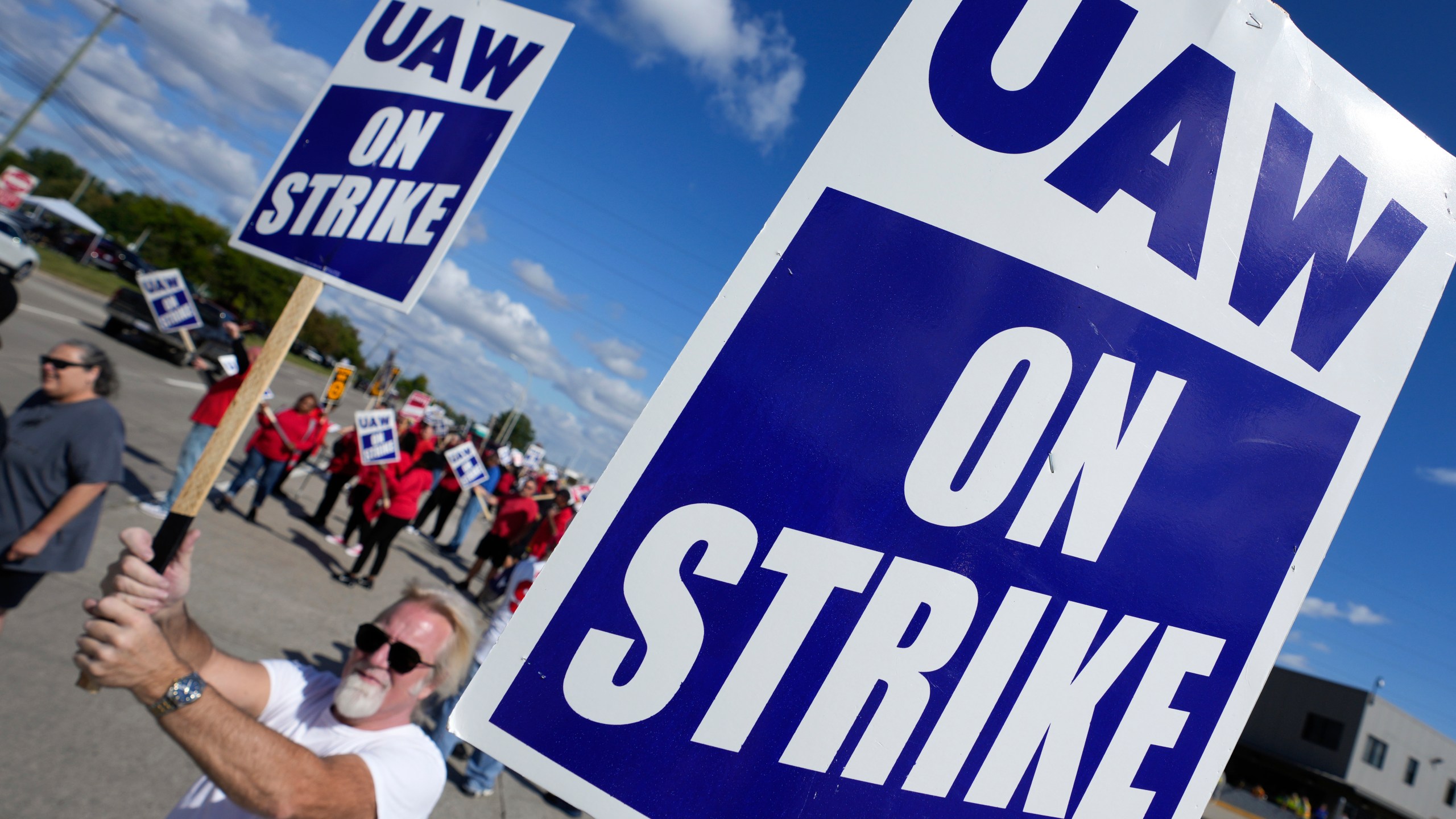 United Auto Workers members walk the picket line at the Ford Michigan Assembly Plant in Wayne, Mich., Monday, Sept. 18, 2023. So far the strike is limited to about 13,000 workers at three factories — one each at GM, Ford and Stellantis. (AP Photo/Paul Sancya)