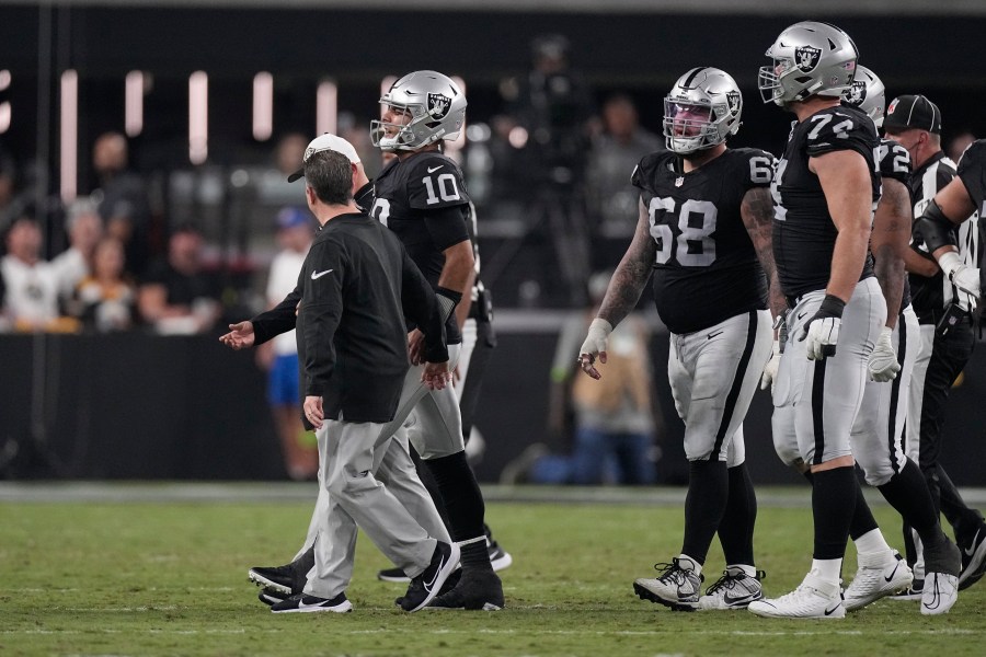 Las Vegas Raiders quarterback Jimmy Garoppolo is helped off the field after being sacked by Pittsburgh Steelers linebacker T.J. Watt during the first half of an NFL football game Sunday, Sept. 24, 2023, in Las Vegas. (AP Photo/Mark J. Terrill)