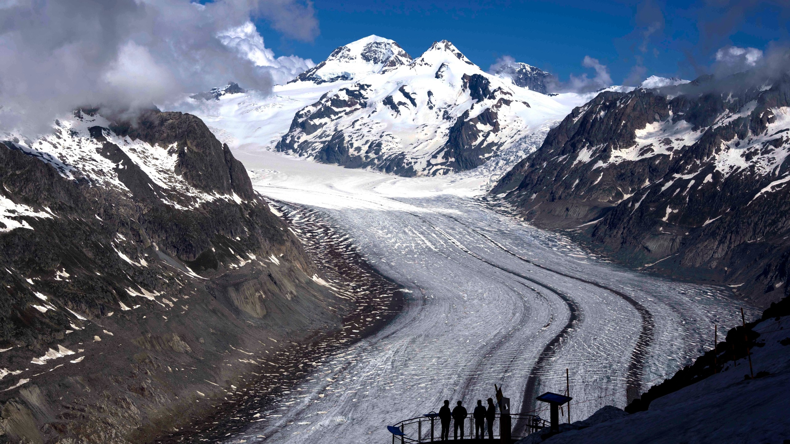 FILE - People enjoy the view at the Aletsch Glacier near Goms, Switzerland, June 14, 2023. (AP Photo/Matthias Schrader, File)