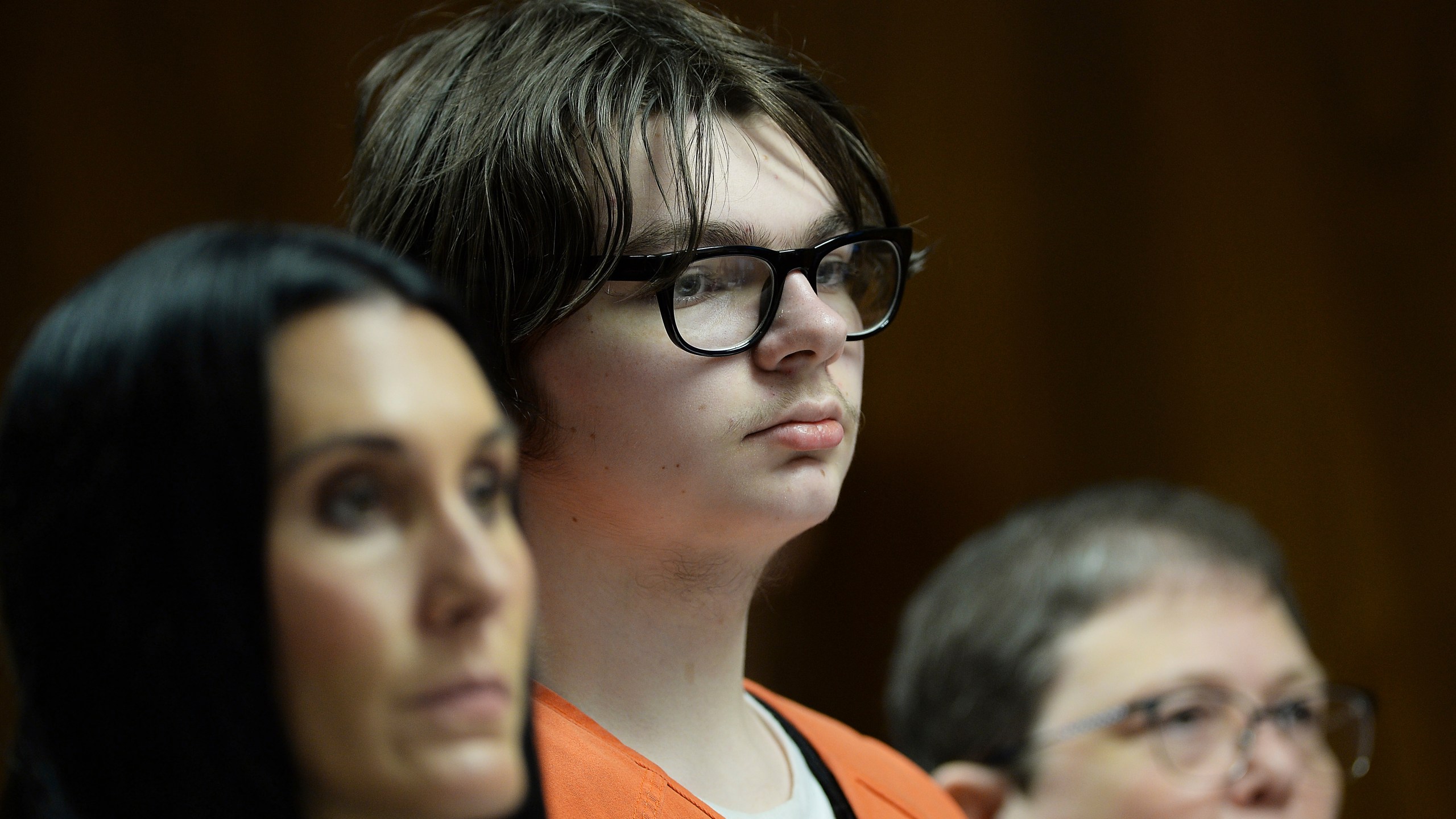 FILE -Ethan Crumbley stands with his attorneys, Paulette Loftin and Amy Hopp during his hearing at Oakland County Circuit Court, Aug. 1, 2023 in Pontiac, Mich. The teenager who killed four students at Michigan’s Oxford High School will learn whether he will spend his life in prison or get a chance for parole in the decades ahead. Judge Kwame Rowe will announce his decision Friday, Sept. 29. (Clarence Tabb Jr./Detroit News via AP, Pool, File)