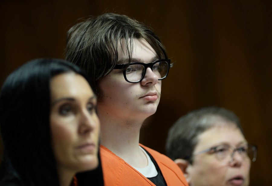 FILE -Ethan Crumbley stands with his attorneys, Paulette Loftin and Amy Hopp during his hearing at Oakland County Circuit Court, Aug. 1, 2023 in Pontiac, Mich. The teenager who killed four students at Michigan’s Oxford High School will learn whether he will spend his life in prison or get a chance for parole in the decades ahead. Judge Kwame Rowe will announce his decision Friday, Sept. 29. (Clarence Tabb Jr./Detroit News via AP, Pool, File)