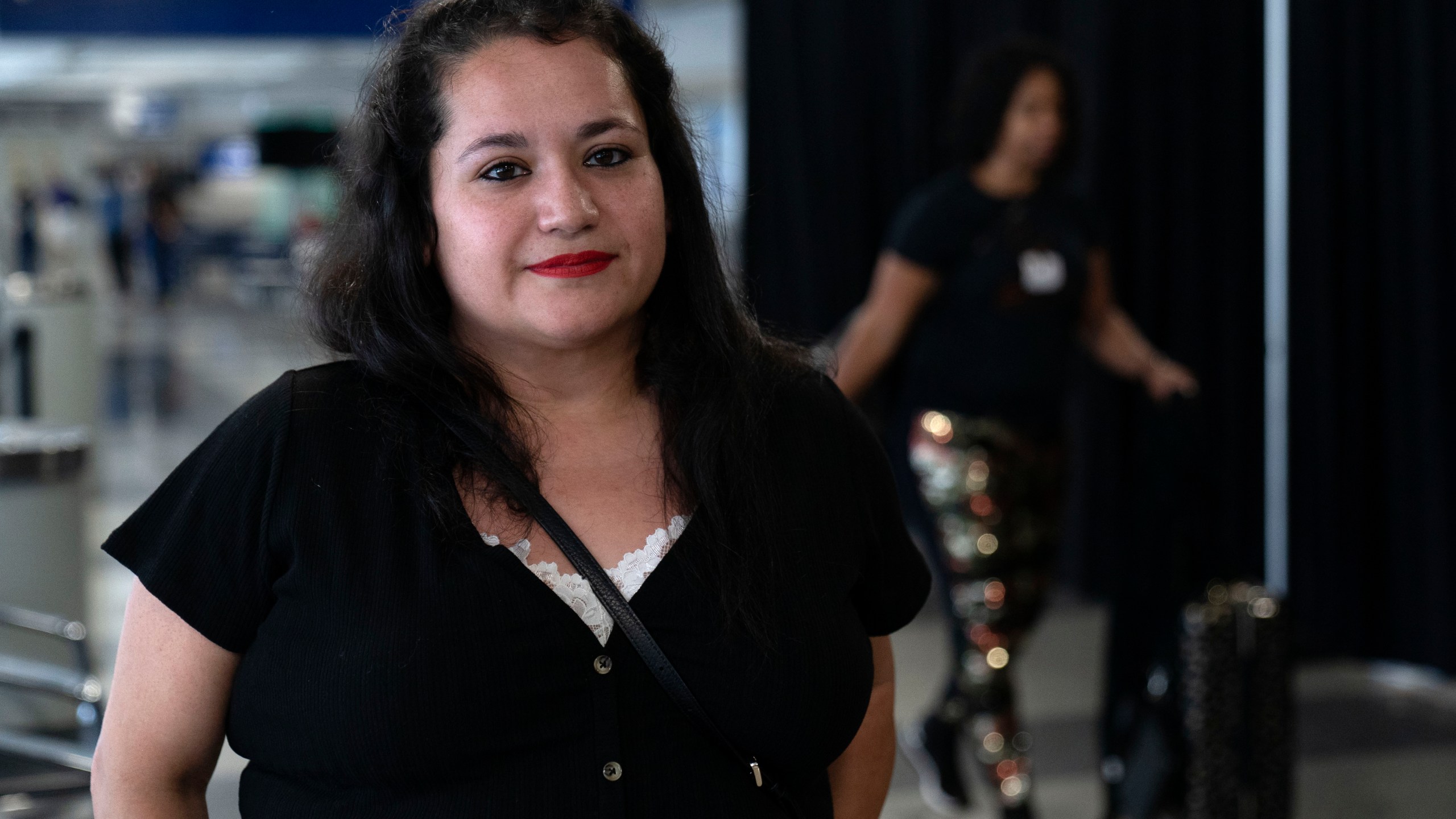 Vianney Marzullo, lead volunteer with the Police Station Response Team organization, stands by a makeshift shelter for migrants at O'Hare International Airport run by a private firm hired by the city, Wednesday, Sept. 20, 2023, in Chicago. (AP Photo/Erin Hooley)