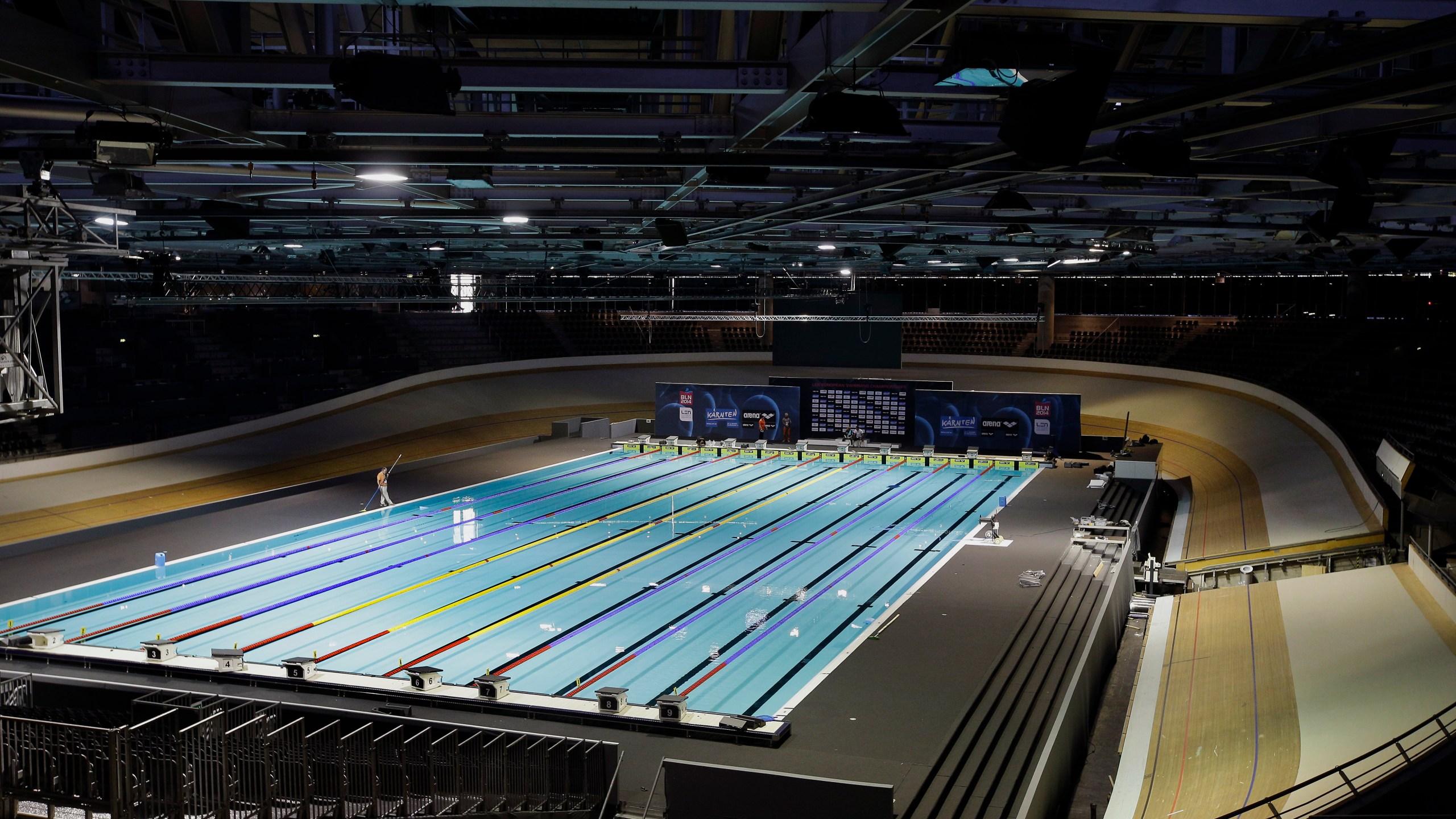 FILE - Workers put finishing touches on a pool for swimming events in Berlin, Germany, Aug. 11, 2014. Plans for the first “open category” swimming races to accommodate transgender competitors at a World Cup this weekend have been scrapped because of a lack of entries. World Aquatics said Tuesday, Oct. 3, 2023 it had received “no entries” for the open category events scheduled to take place at a World Cup starting Friday in Berlin. (AP Photo/Michael Sohn, file)