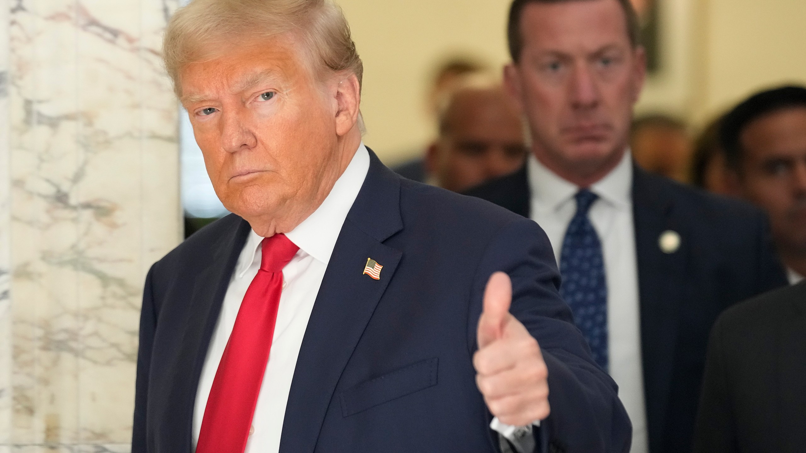 Former President Donald Trump motions to the media as he walks out of the courtroom during a break in his civil business fraud trial at New York Supreme Court, Tuesday, Oct. 3, 2023, in New York. Trump is in court for the second day of his trial. A day after fiery opening statements, lawyers in the case are moving Tuesday to the plodding task of going through years' worth of Trump's financial documents. (AP Photo/Seth Wenig)