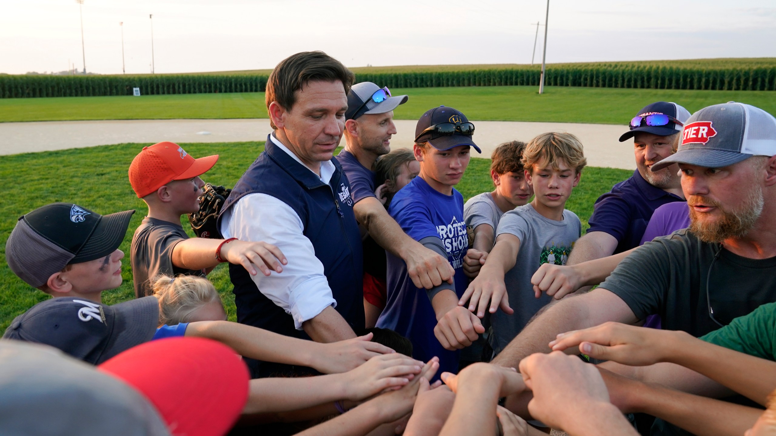 FILE - Republican presidential candidate Florida Gov. Ron DeSantis interacts with local players during a campaign stop at the Field of Dreams movie site, Thursday, Aug. 24, 2023, in Dyersville, Iowa. (AP Photo/Charlie Neibergall, File)