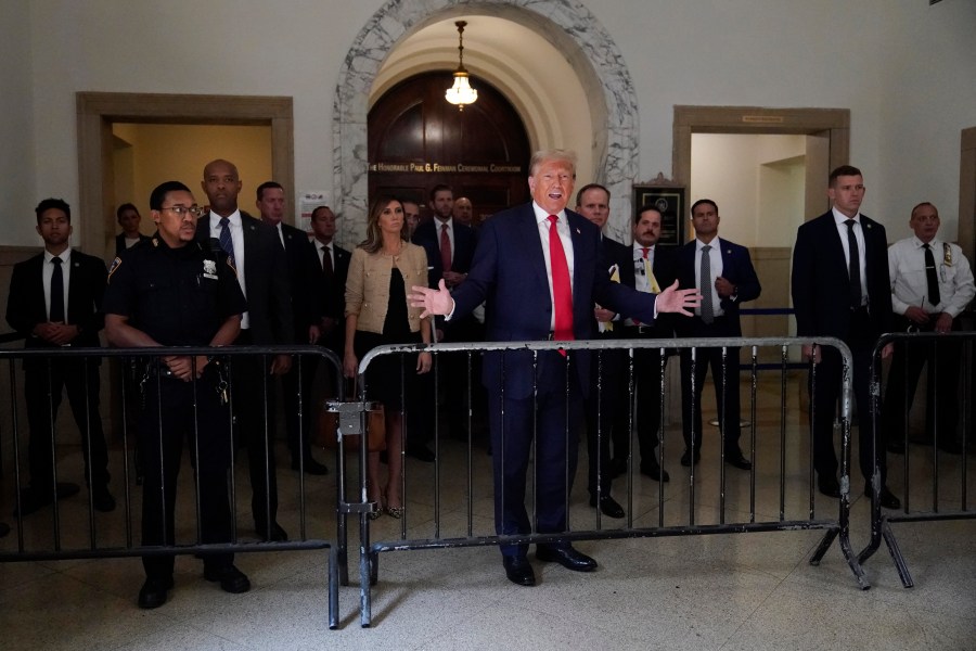 Former President Donald Trump speaks to reporters as he leaves the courtroom during a lunch break in his civil business fraud trial, Wednesday, Oct. 4, 2023, in New York. (AP Photo/Mary Altaffer)