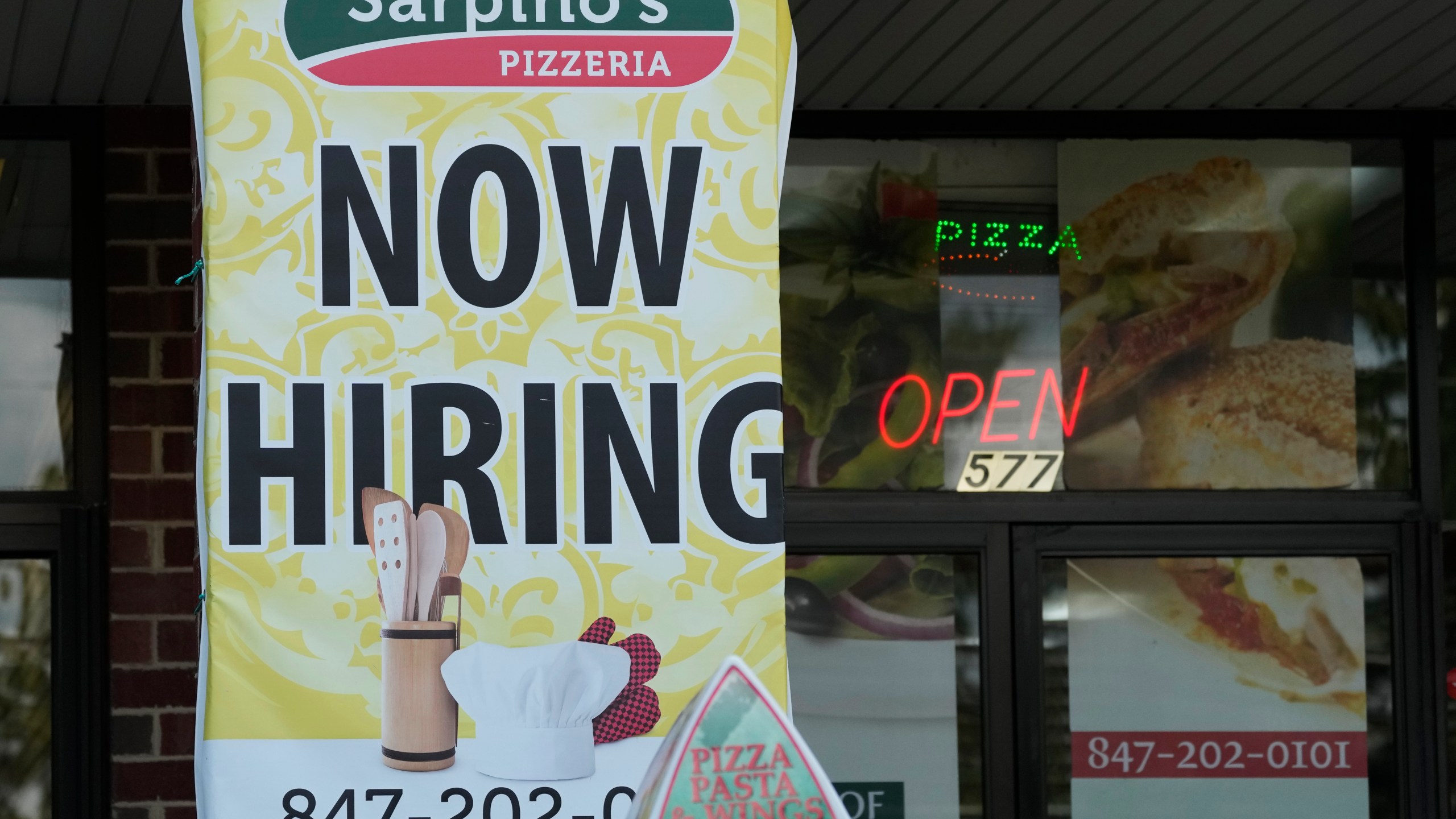 A hiring sign is displayed at a restaurant in Palatine, Ill., Wednesday, Sept. 13, 2023. On Thursday, the Labor Department reports on the number of people who applied for unemployment benefits last week. (AP Photo/Nam Y. Huh)