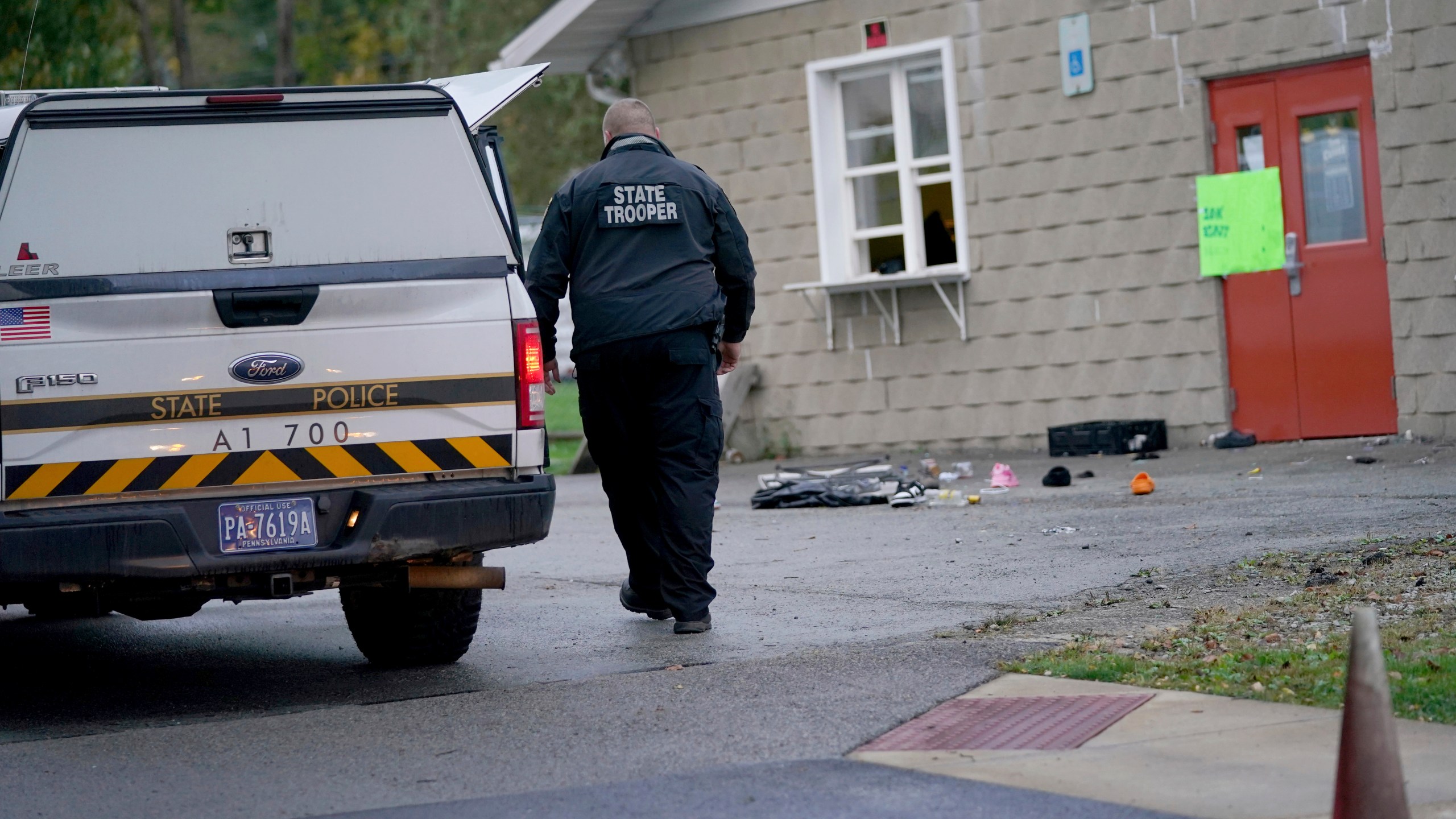 A trooper from the Pennsylvania State Police Reconstruction Unit works at the crime scene of a fatal shooting at the Chevy Chase Community Center, Sunday, Oct. 8, 2023, in White Township, Indiana County, Pa. State police in Indiana County said troopers, local officers and emergency services responded at 12:35 a.m. Sunday to the shooting at the center in White Township, about 50 miles (80 kilometers) northeast of Pittsburgh. (Sean Stipp/TribLIVE.com via AP)