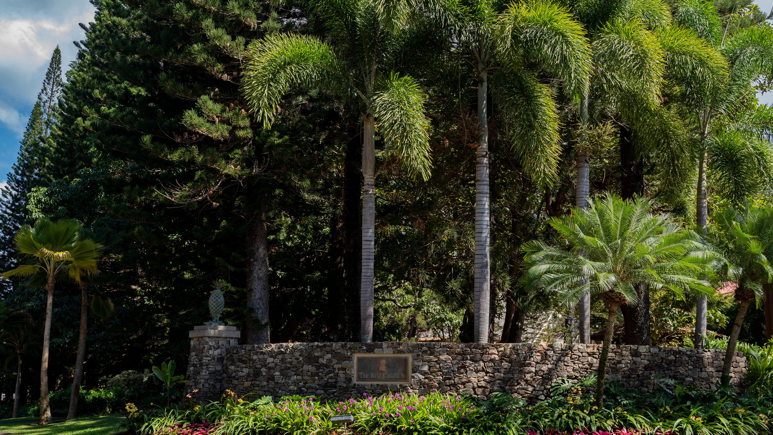 A sign for The Ritz-Carlton, Kapalua, is viewed Tuesday, Oct. 3, 2023, in Lahaina, Hawaii. The resort will re-open Sunday, Oct. 8, 2023, as the first phase for tourism returning to West Maui. (AP Photo/Mengshin Lin)